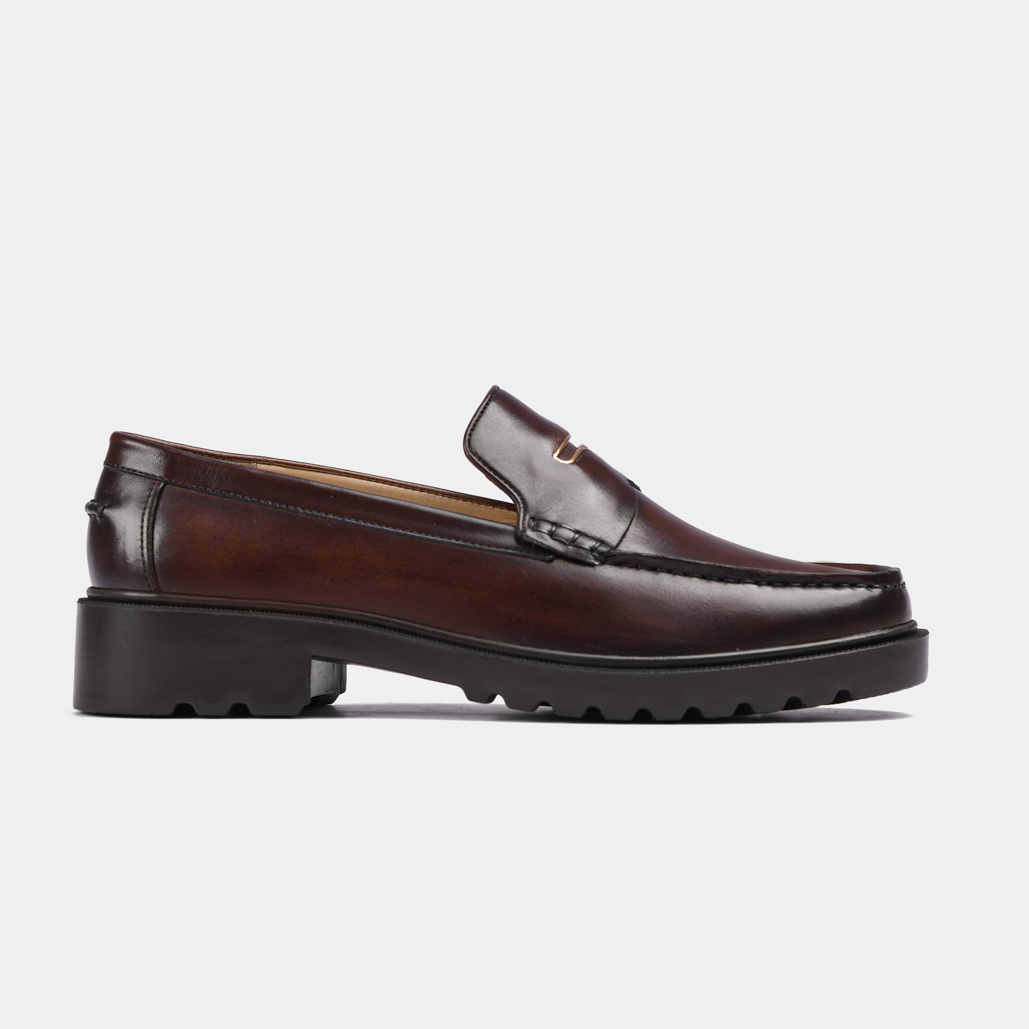 A side view of brown leather Solesculpt Lite loafers with a chunky black sole.