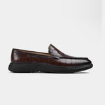 Pair of brown croc-embossed leather slip-on shoes for men with a flexible black sole.