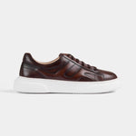 Side view of Luxoro Signature brown leather sneakers with white soles.