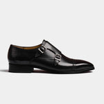 A side view of the Nacario Black Monk Straps, showcasing the polished black leather and silver buckle details on these stylish men's dress shoes.