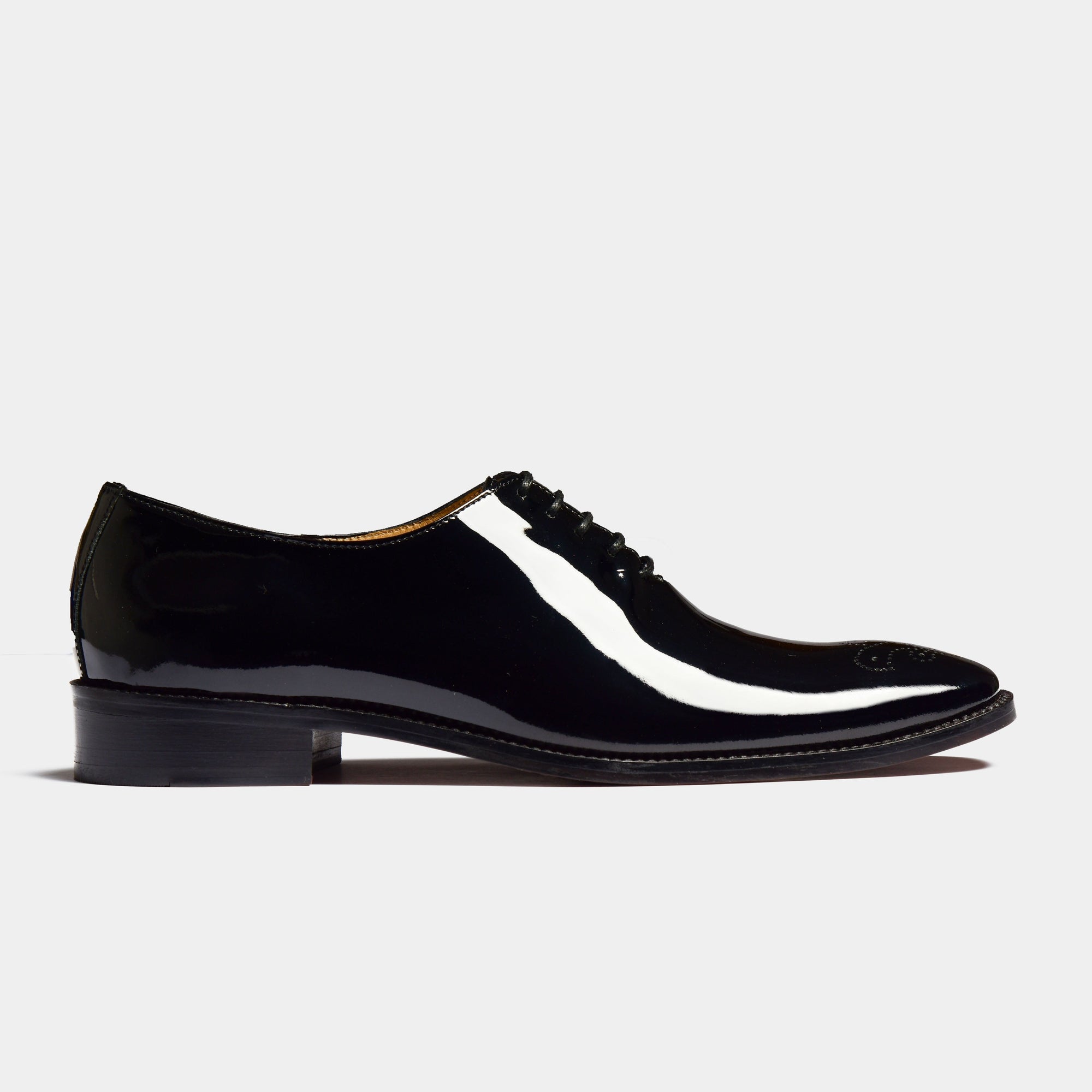 A single Oscar Noir Lace Up shoe, showcasing its sleek, black patent leather upper and classic lace-up design on a white background.