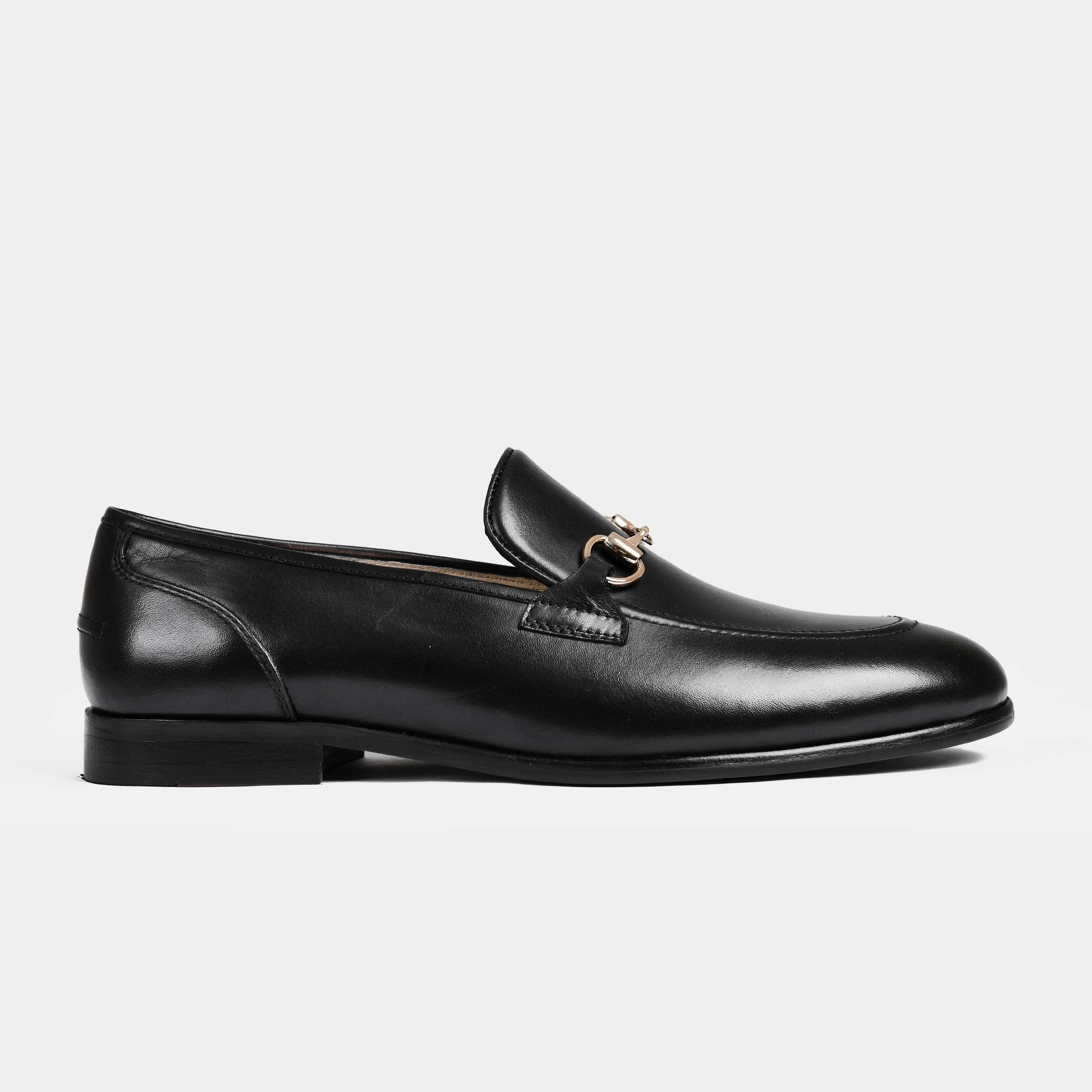 A pair of Emerald Black Leather Loafers with gold chain detailing on the vamp.