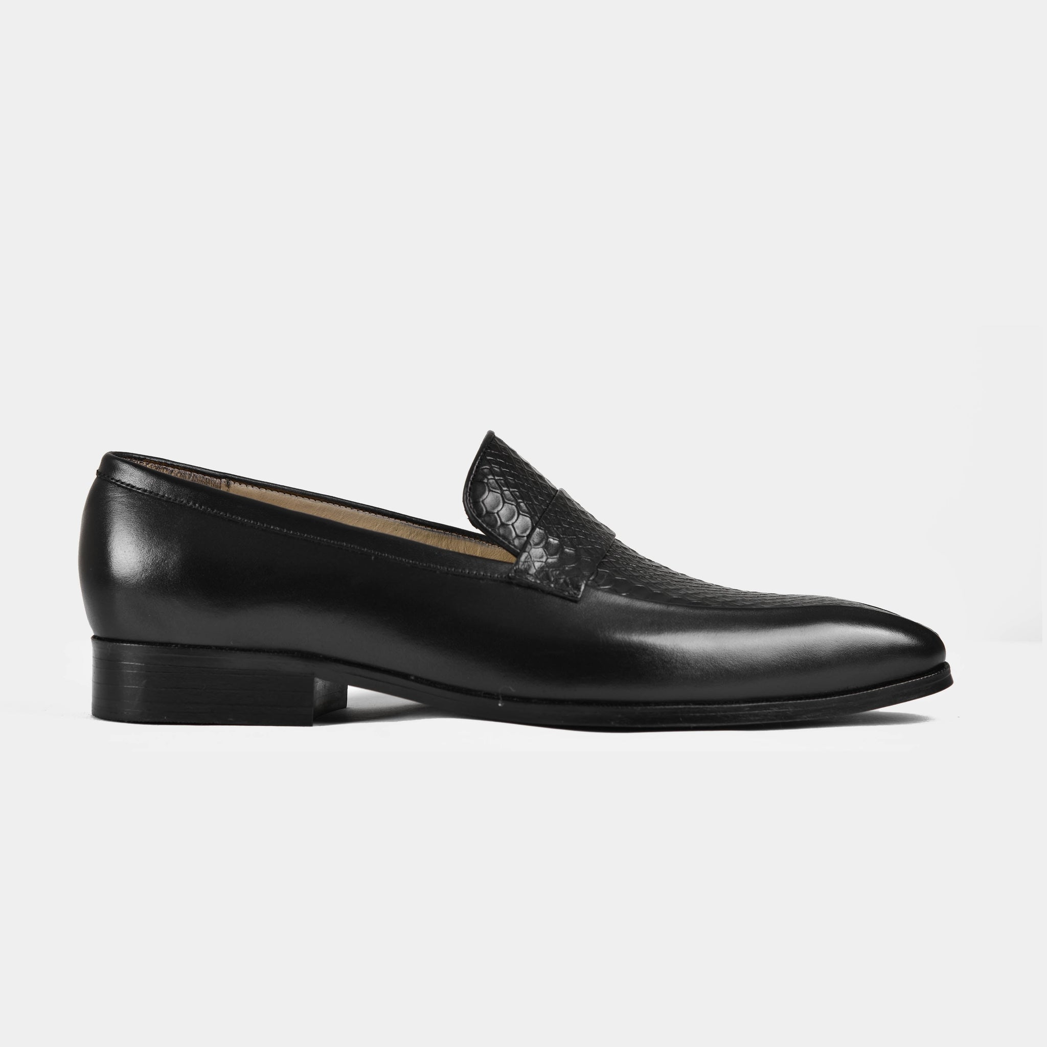 Pair of black leather Jorge penny loafers for men with a textured vamp, shown in a side view.