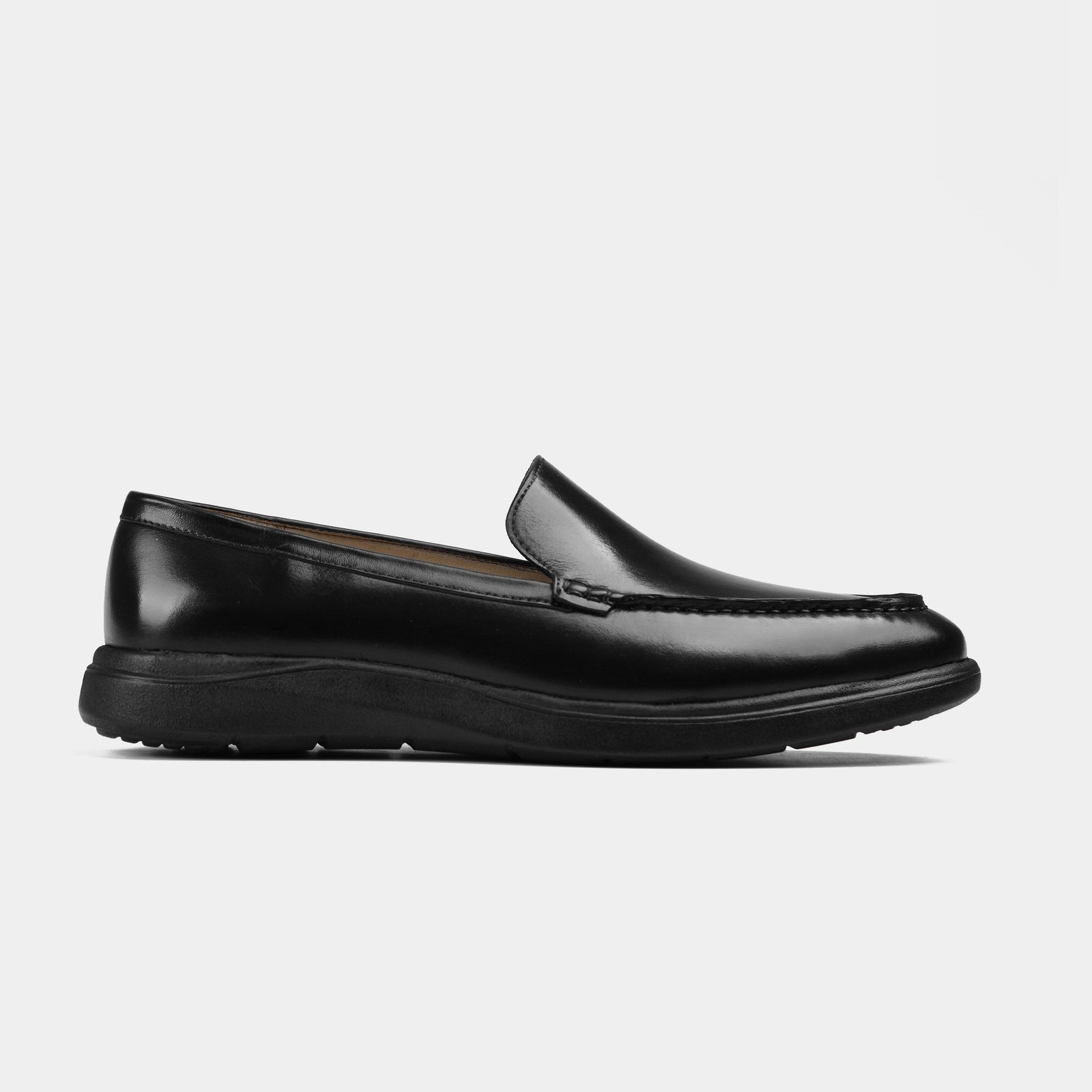 Pair of black burnished leather slip-on shoes with flexible Aero-Flex soles, shown from the side.