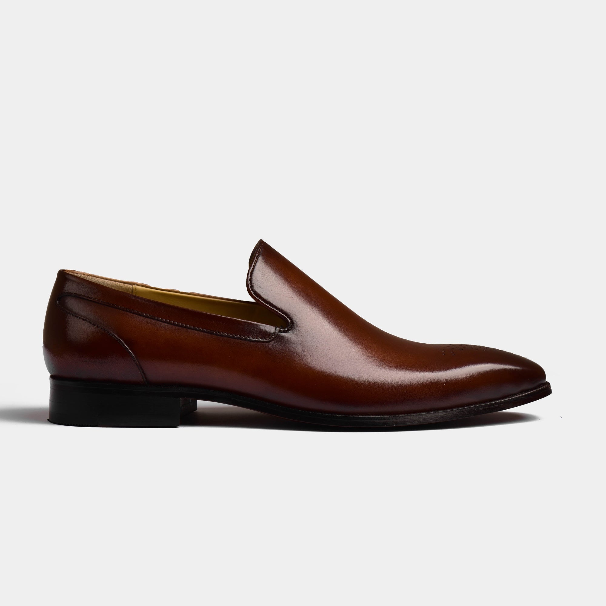 Side view of Charles Choc Leather Loafers, showcasing their sleek design and rich brown leather.