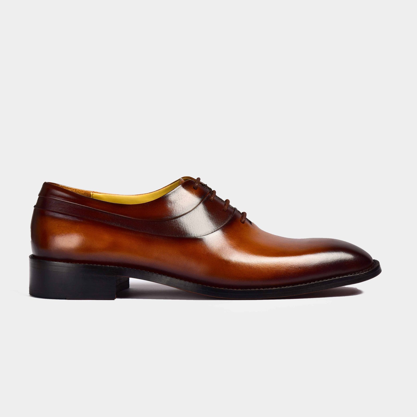 Side view of Charles Cognac Tan Leather Lace-ups, showcasing the polished finish of these stylish men's dress shoes.