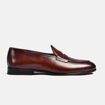 Side view of a brown leather Arno Loafer with a classic penny strap detail.