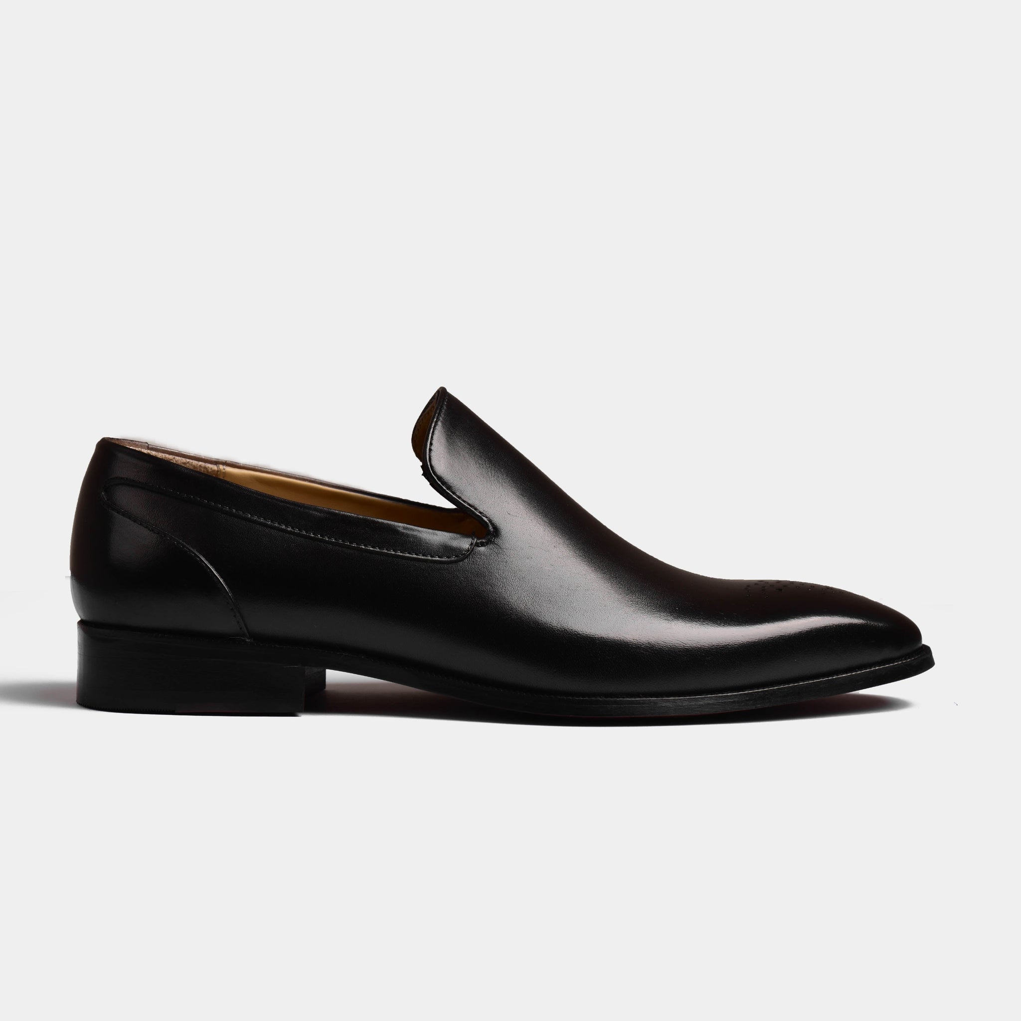 A single black leather Madrid loafer shoe on a white background.