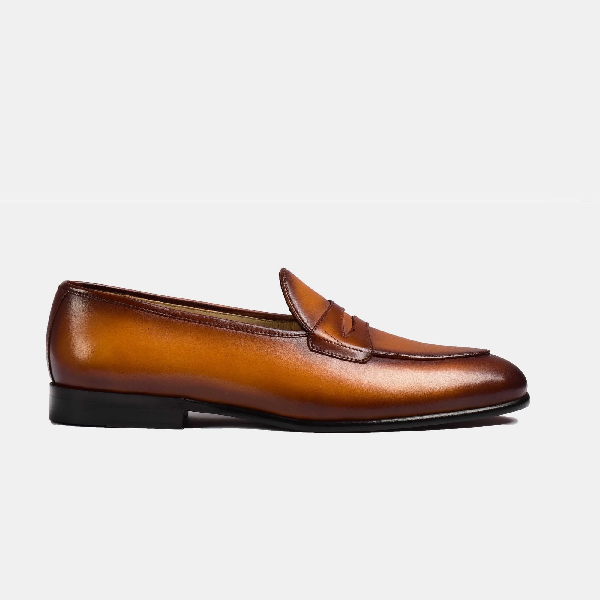 Tan hand-painted leather Arno loafers with a classic penny loafer design and hand-stitched detailing.