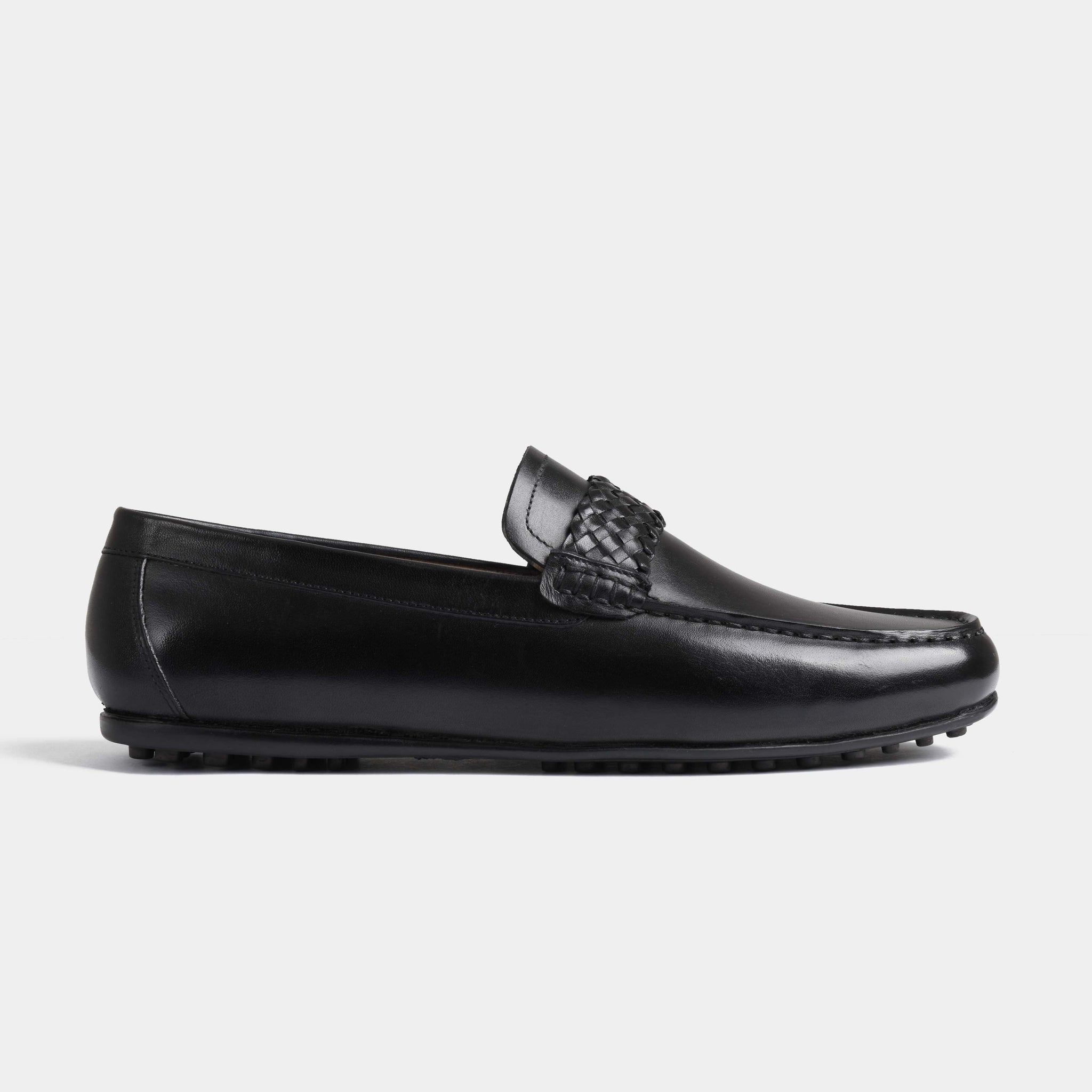 A side view of the Denver Black Leather Driving Loafers showcasing the sleek black leather and woven detailing.