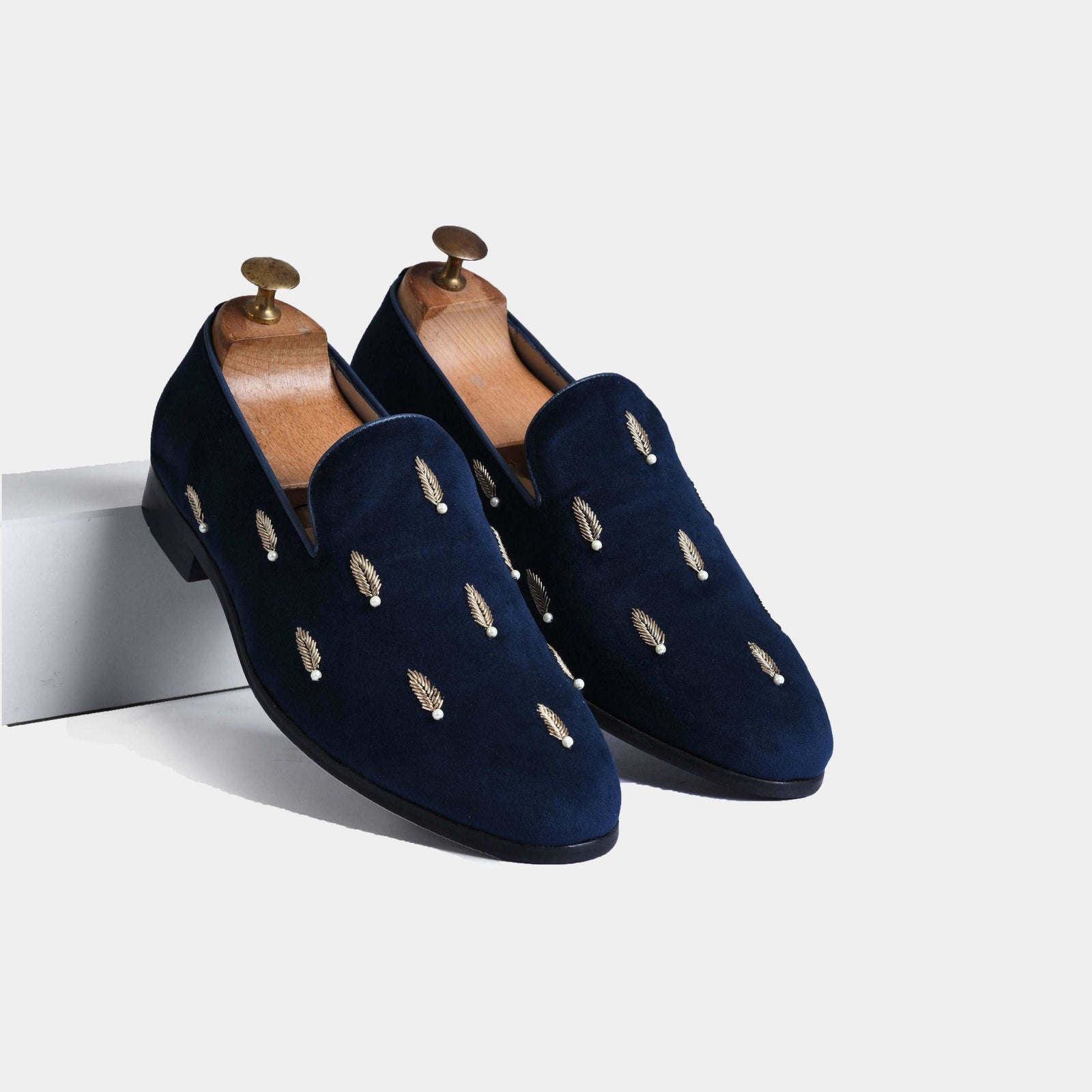 Pair of Carlos Blue Embroidered Leather Slip-Ons with gold leaf and pearl accents.