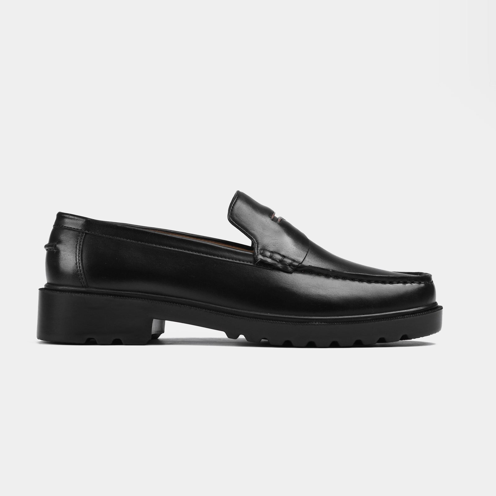 A pair of black leather loafers with a chunky sole. Solesculpt Lite technology ensures these loafers are both stylish and comfortable.