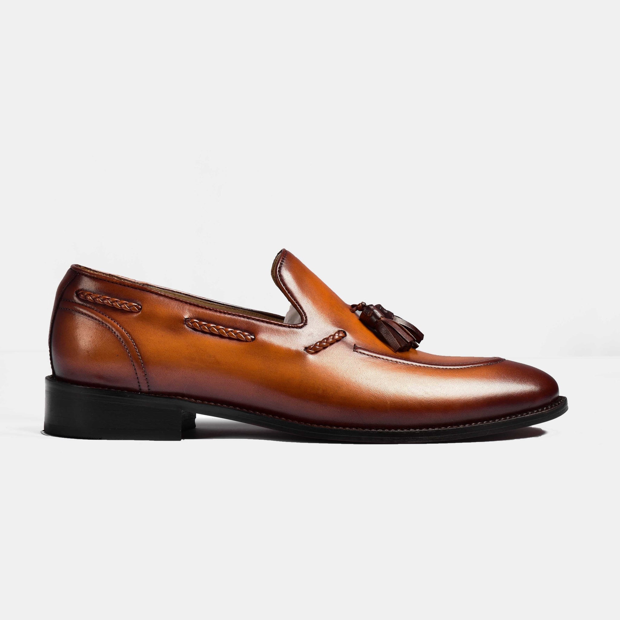 Side view of a tan pair of Wilson Miller Leather Loafers with braided tassels.