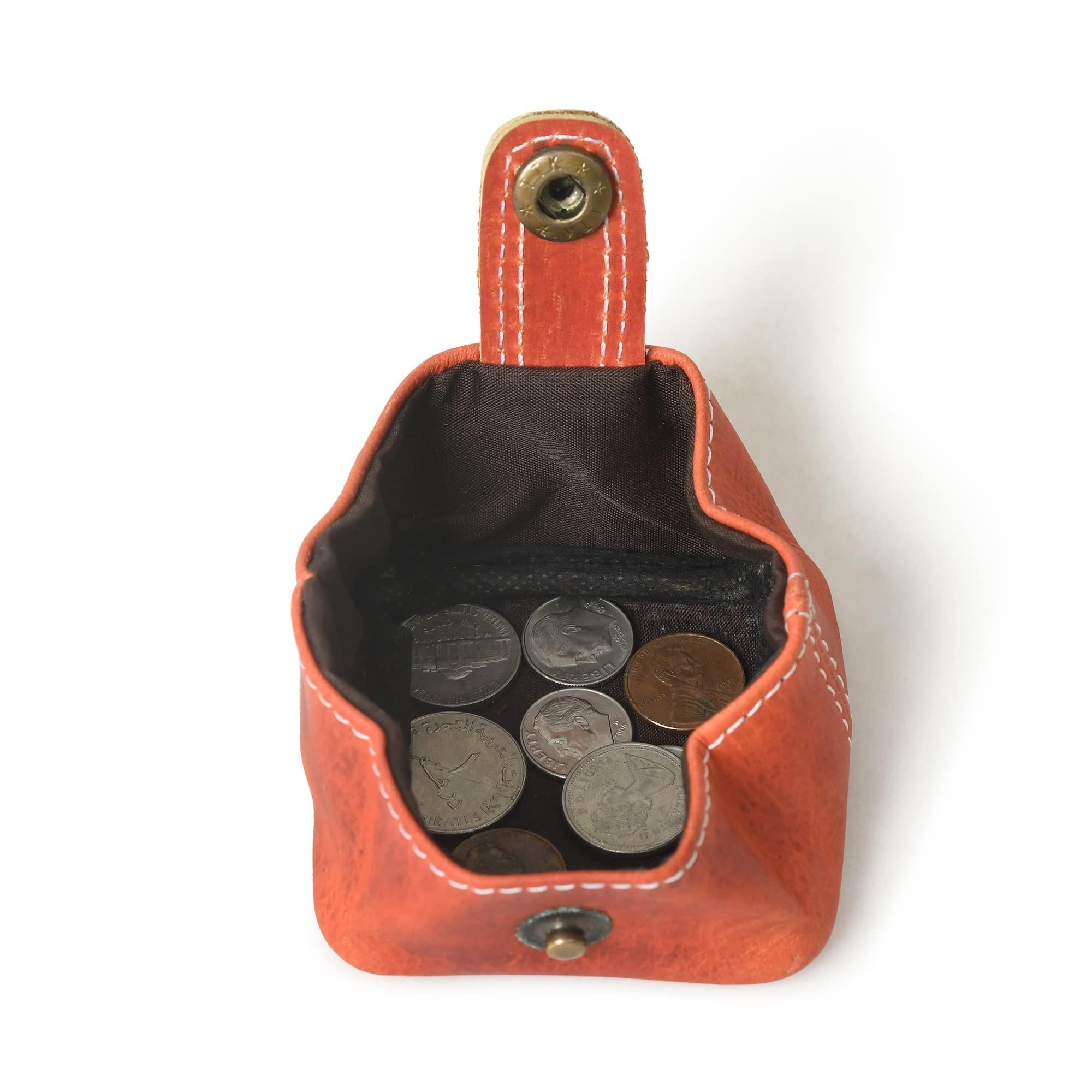 Open orange leather mini pocket wallet with snap closure, showcasing its compact size and capacity to hold coins.