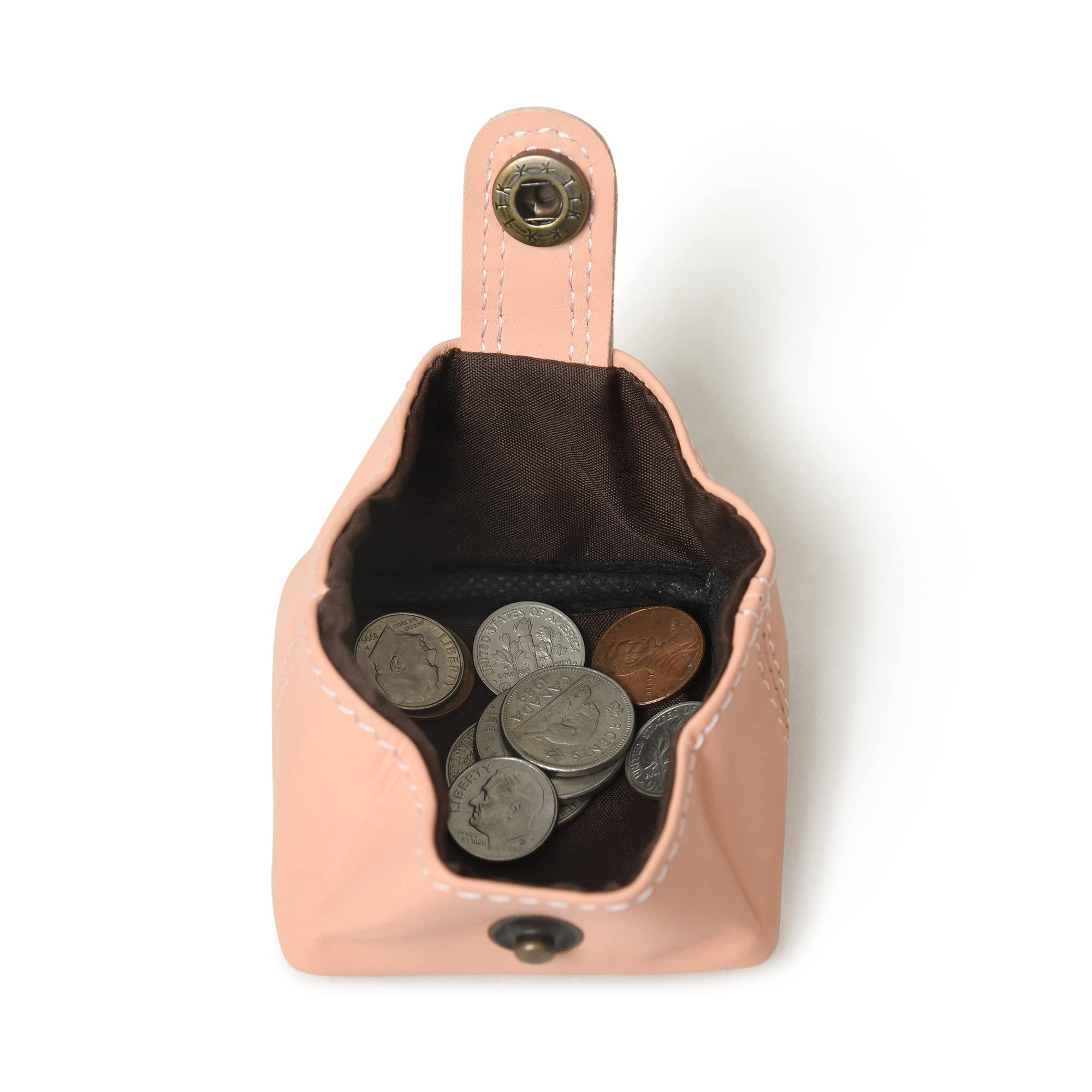 Open peach leather coin purse with snap closure, showcasing its interior and capacity to hold coins.