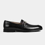 A pair of Damian Black Loafers with a gold buckle detail, showcasing their sleek and polished design.