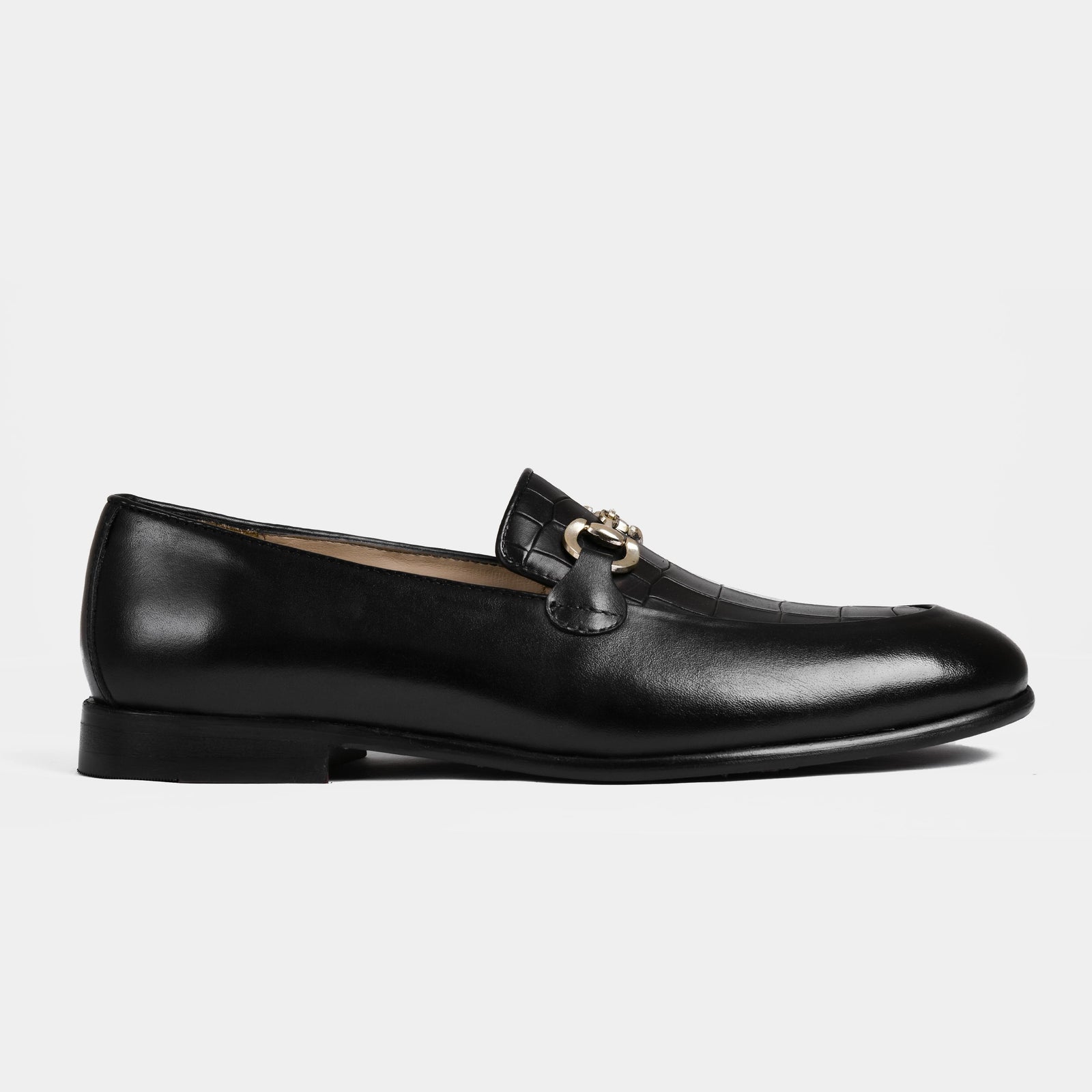 A pair of Damian Black Loafers with a gold buckle detail, showcasing their sleek and polished design.