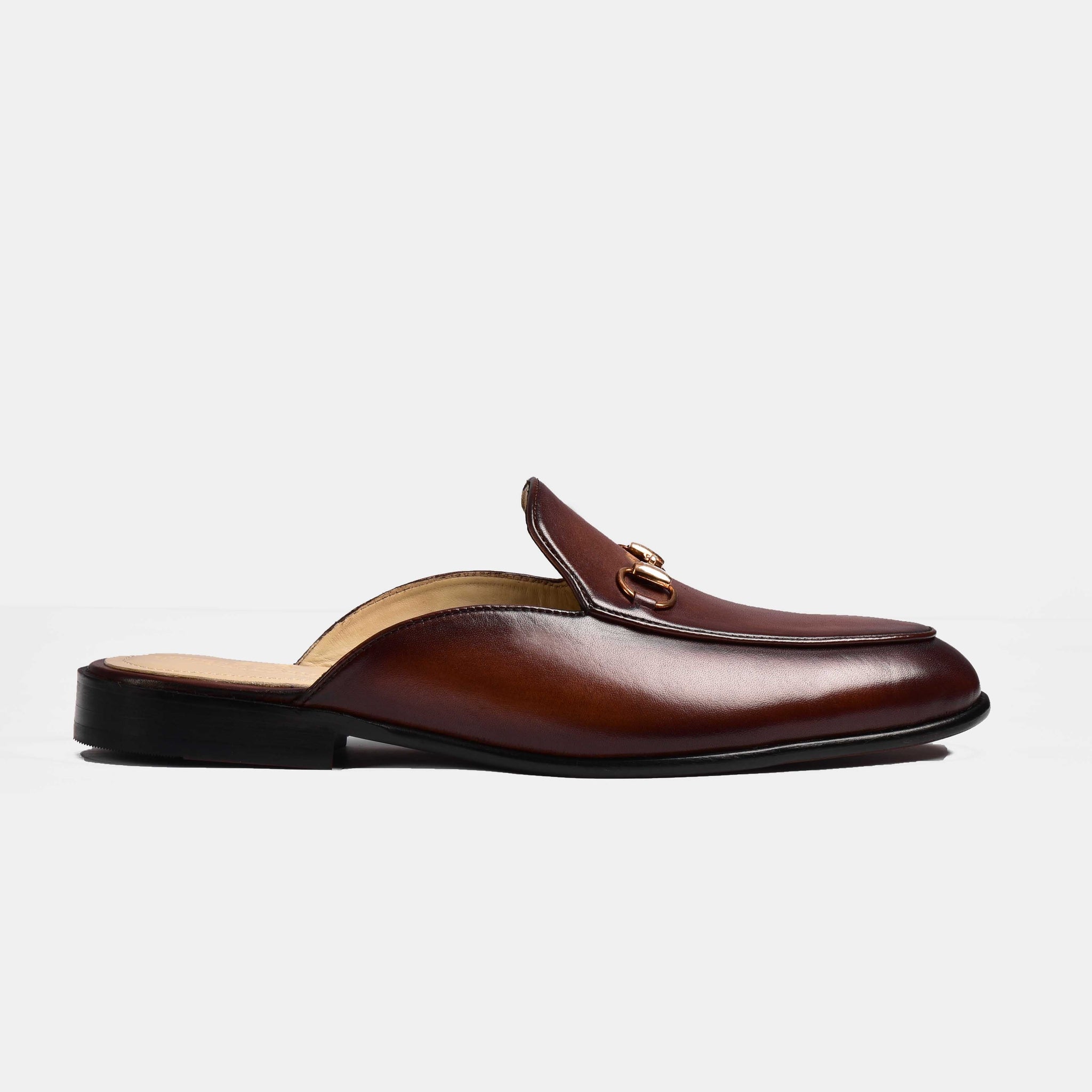 Brown leather Arno formal mules with gold metal trim, shown in profile.