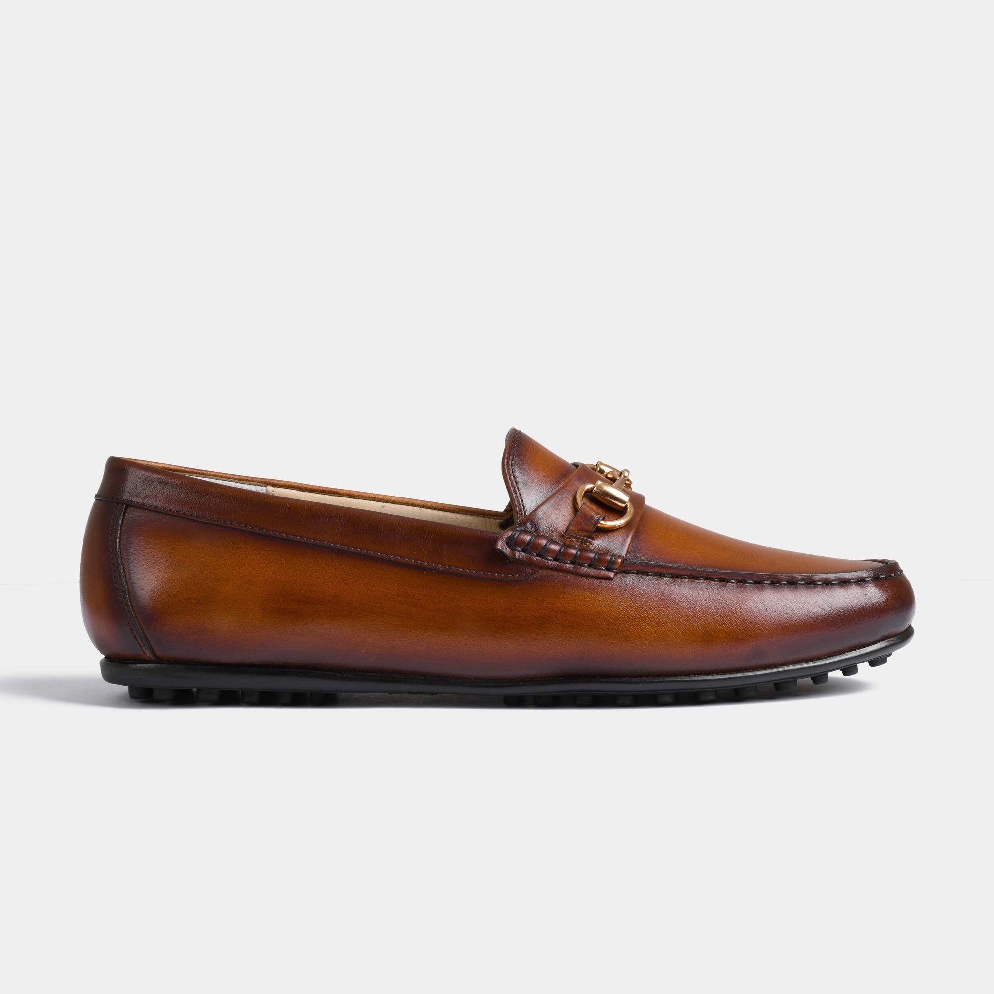 Pair of Marco Tan Leather Driving Loafers with a gold bit detail, shown in a side view.