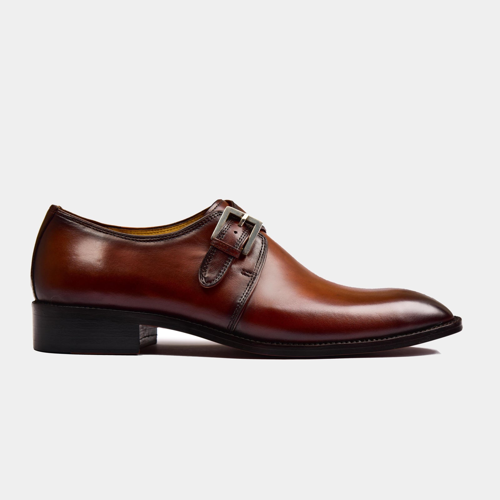 Side view of a stylish brown Ross Single Leather Monk Strap shoe with a silver buckle.