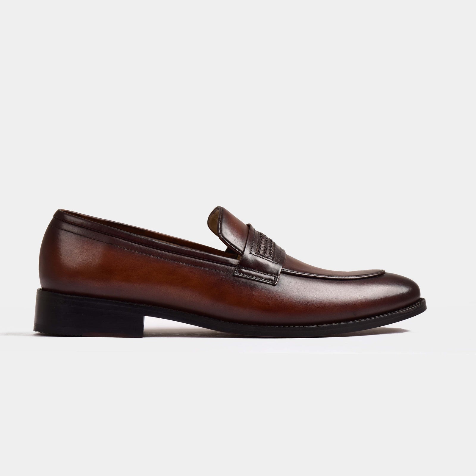 A pair of Tim Williams Leather Loafers in rich brown leather, showcasing a classic silhouette and intricate stitching details.