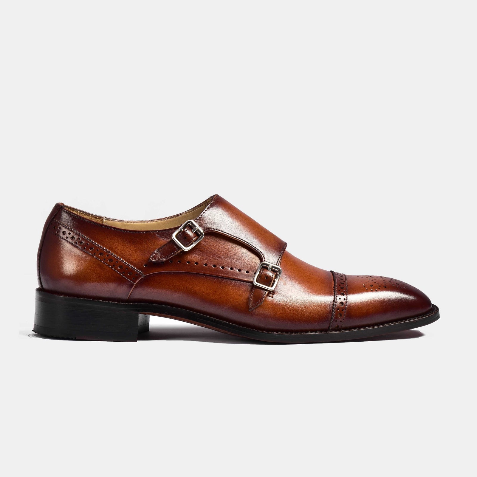 A side view of Henry Tan Double Leather Monk Straps in brown leather, featuring double monk straps and brogue detailing.