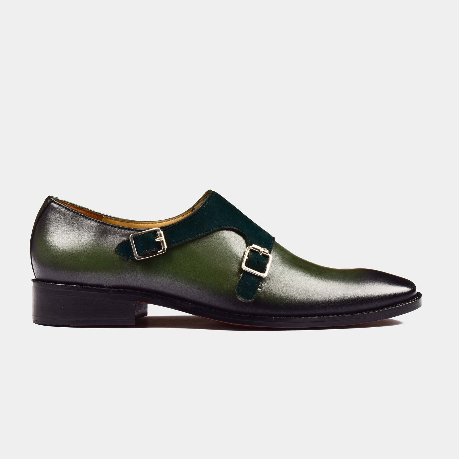 A pair of Chris Parker Leather Monk Straps in green leather with double silver buckles on a white background.