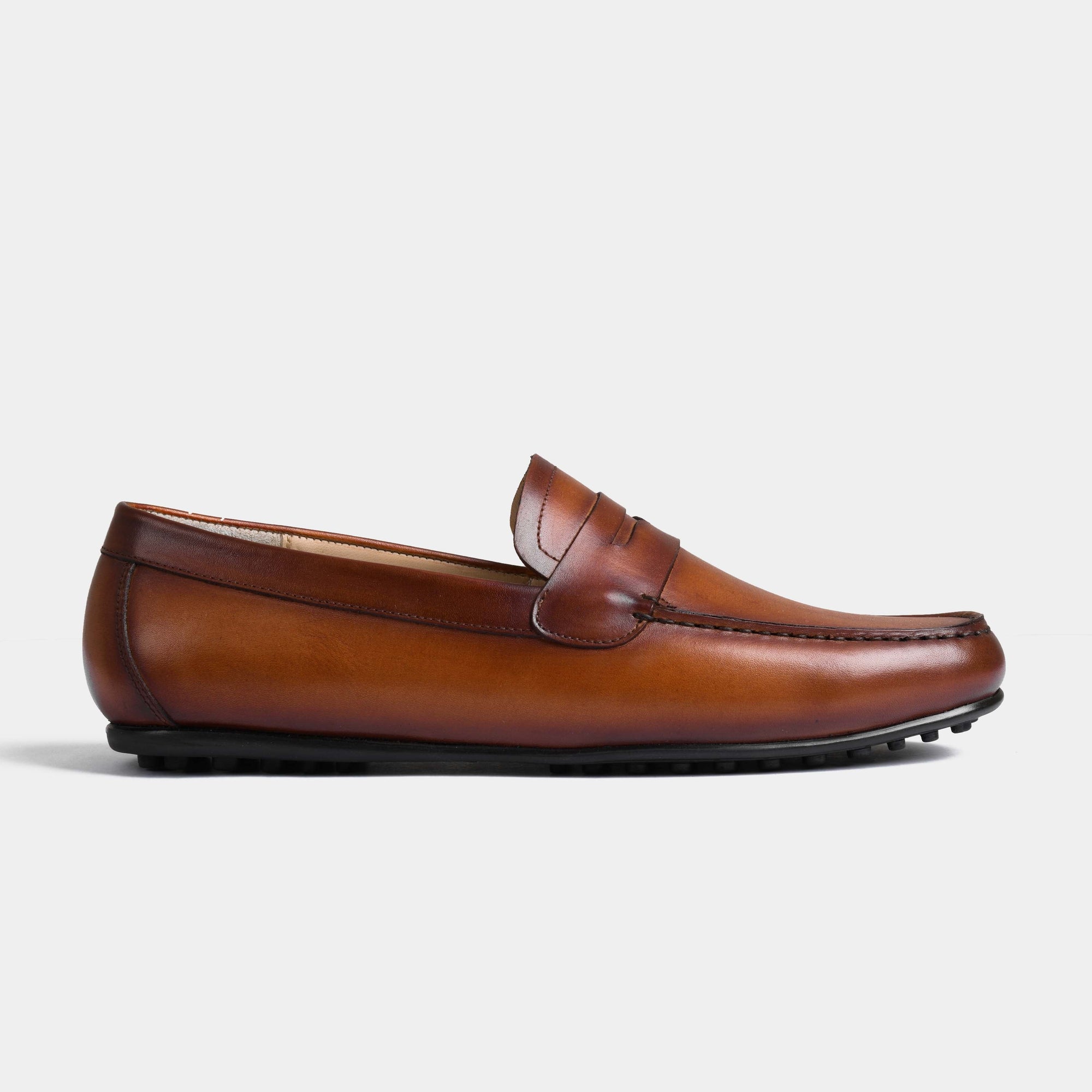 Side view of a single Javier Tan Leather Driving Loafer with a black sole on a white background.