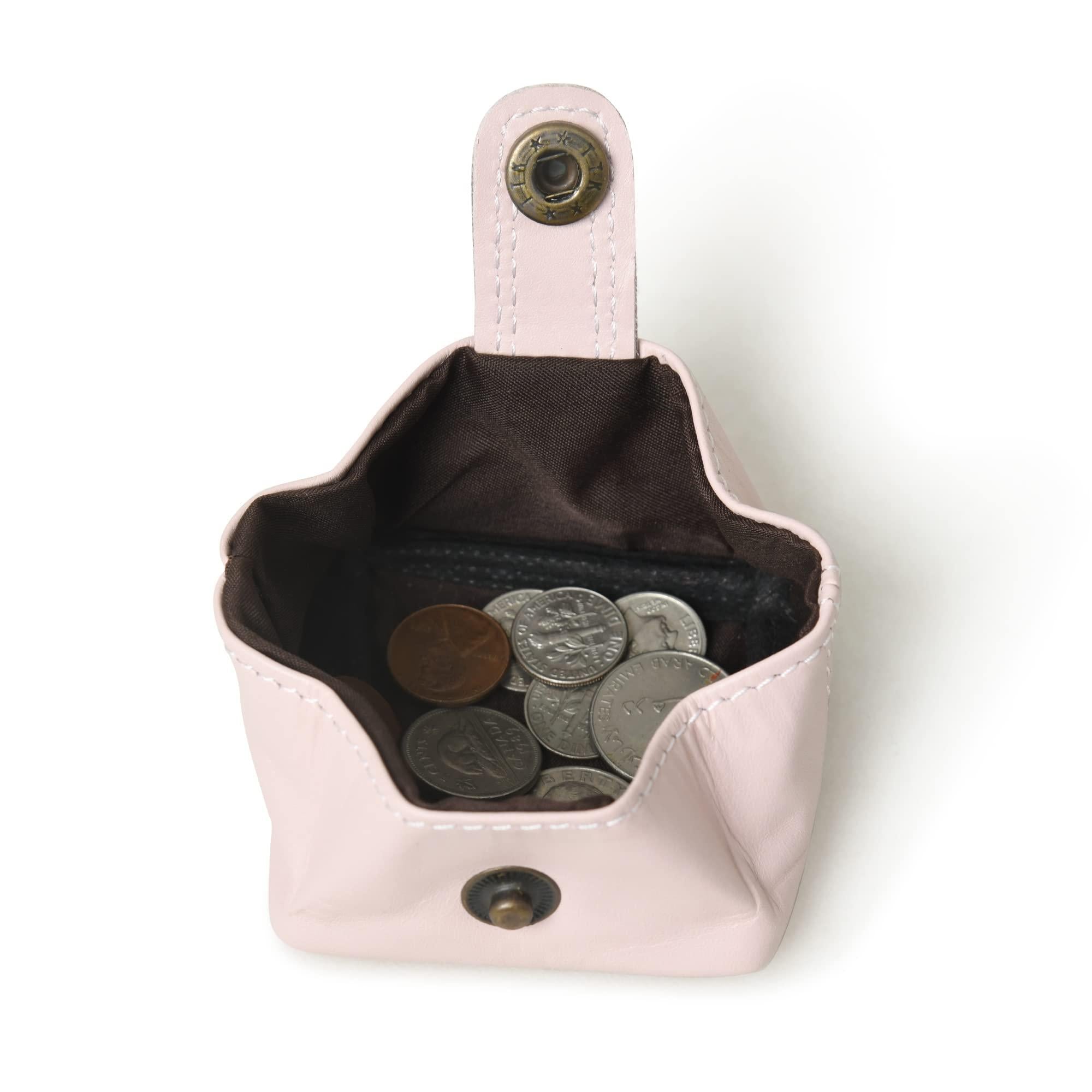 Open baby pink leather coin purse with snap closure, showcasing its brown lining and filled with various coins.