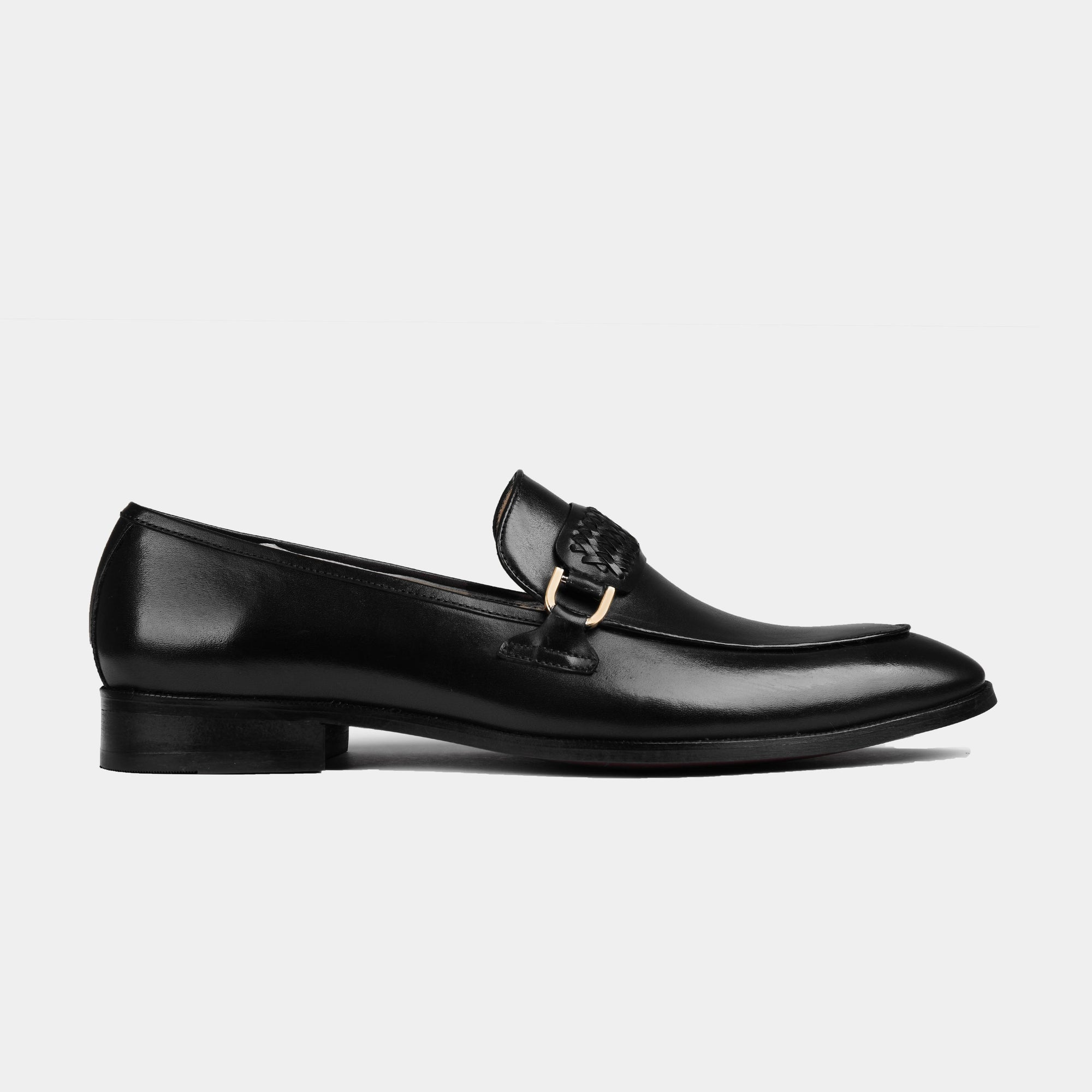 A pair of Cesar Black Leather Loafers with a woven leather strap and gold buckle detail.