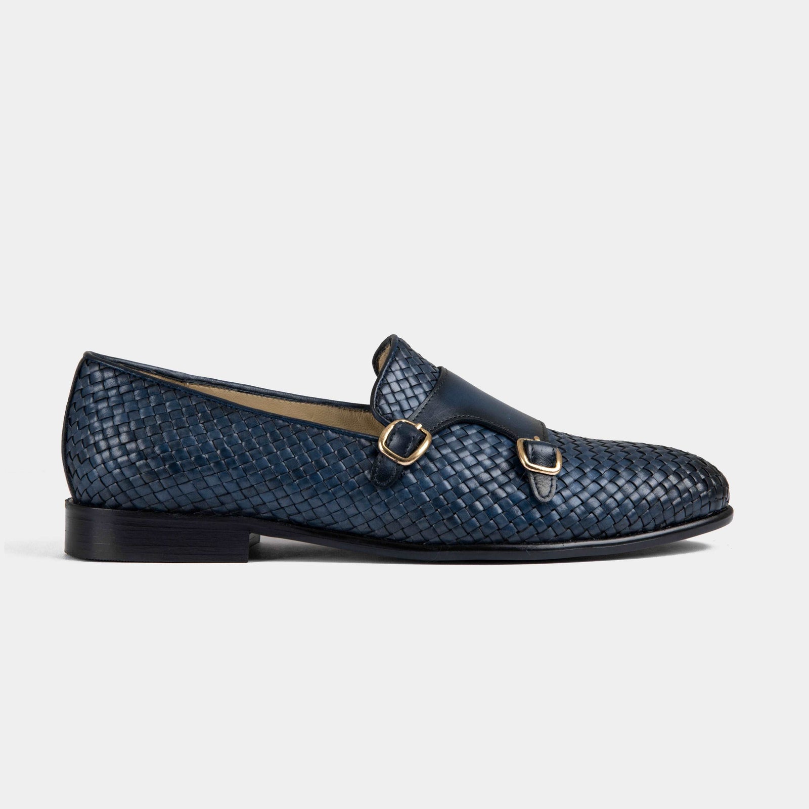 Pair of navy blue Ciro Weaved leather monk strap shoes with a woven design and gold buckles.