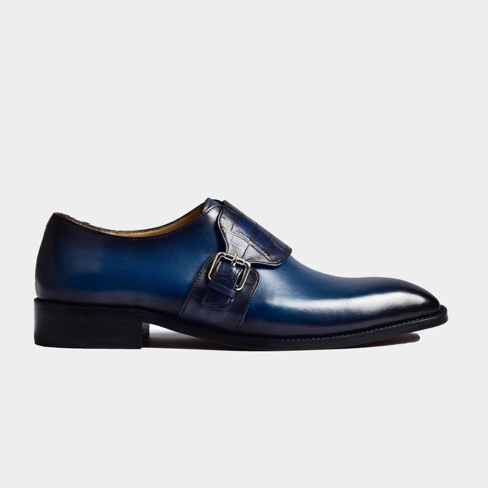 A side view of the Henry Blue Single Monk Strap Leather shoes, showcasing the blue leather and single buckle detail.