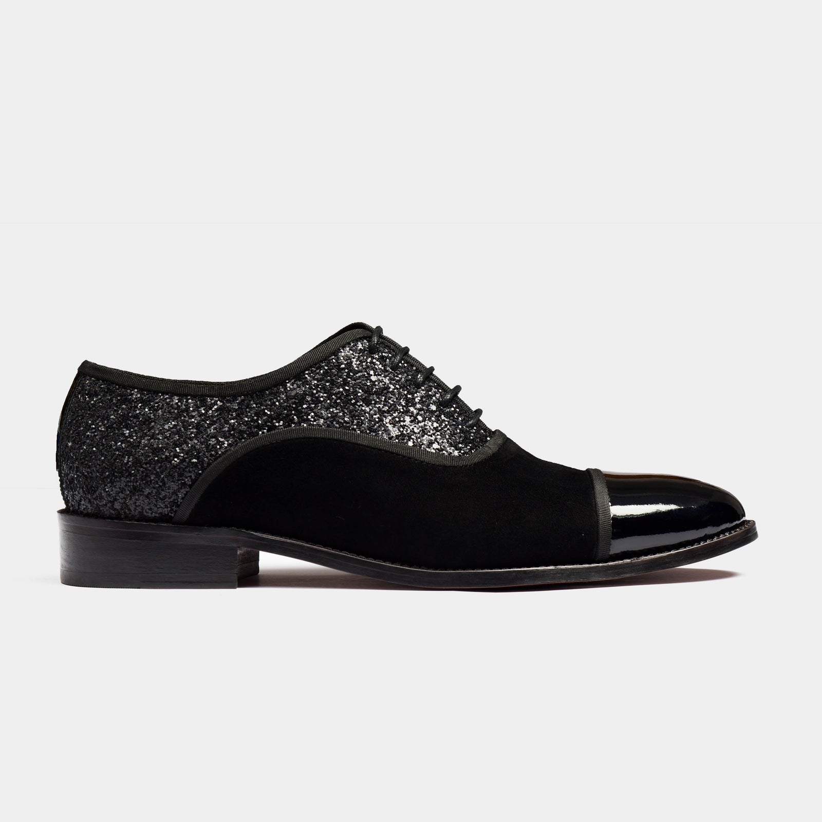 Pair of Liam Glitz Leather Laceups in black with black glitter detailing on the back and a patent leather toe cap.