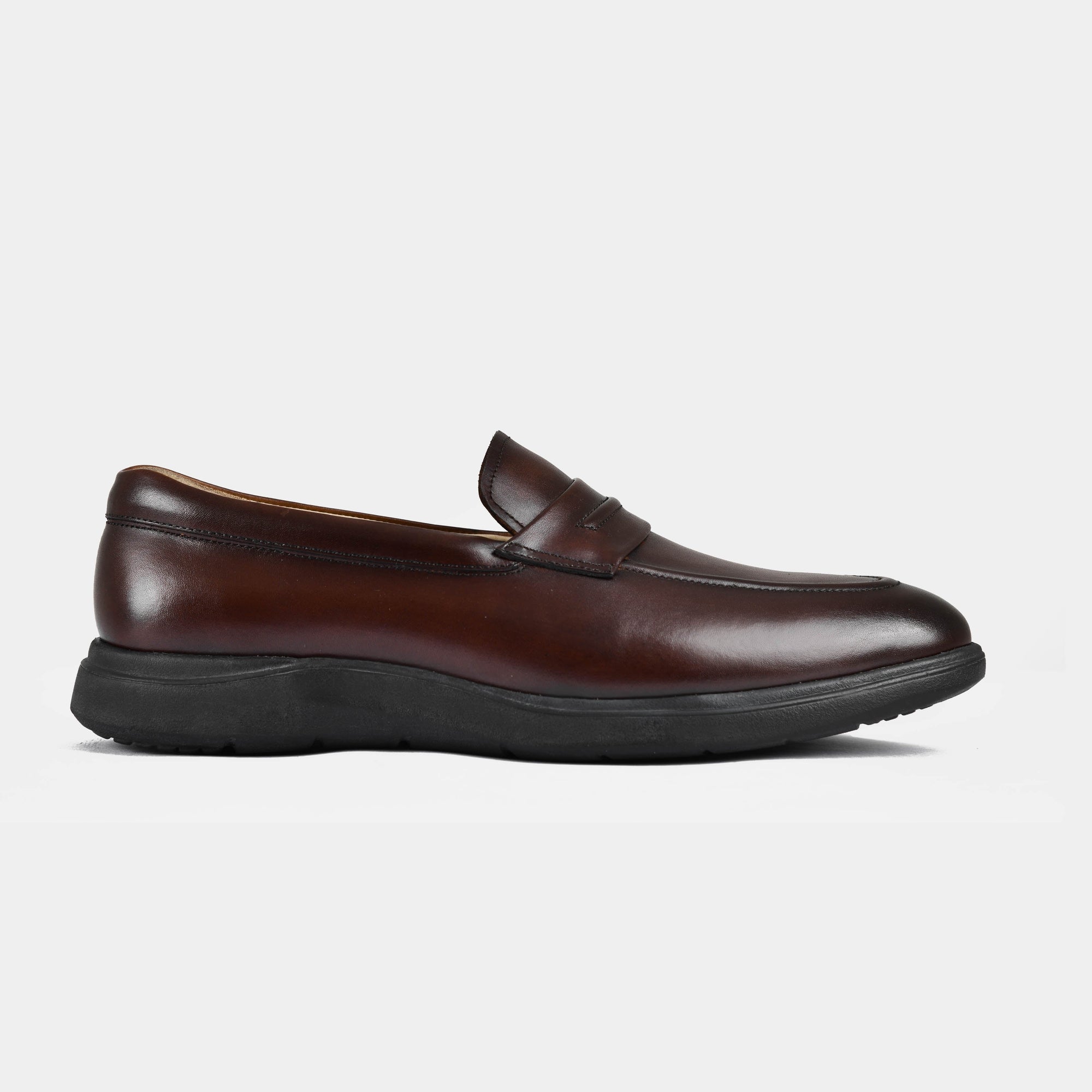 Side view of a brown leather penny loafer, showcasing its sleek design and durable black sole. Brown Penny Leather Slip-Ons | Aero-Flex.