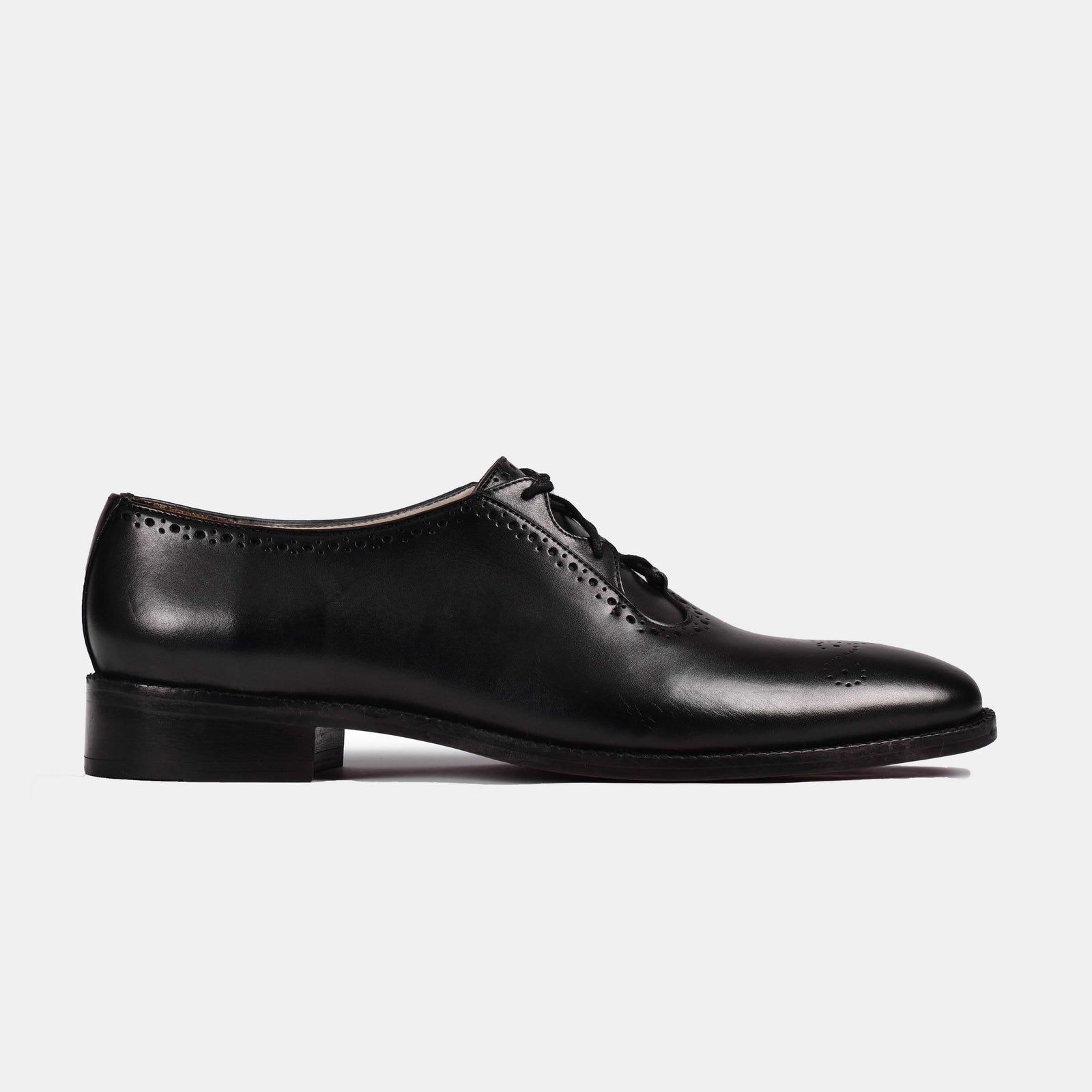 Side view of a single black Ronald Lace Ups dress shoe with broguing details.