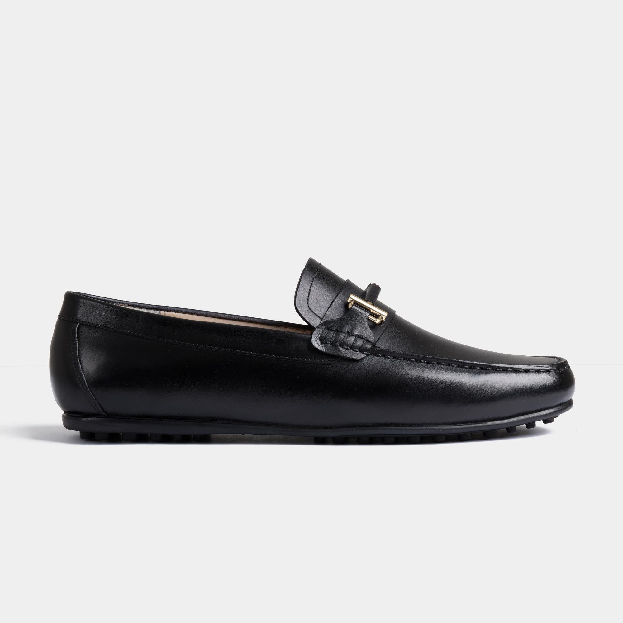 A pair of Diablo Black Driving Loafers with a gold buckle accent, showcasing their sleek and stylish design.