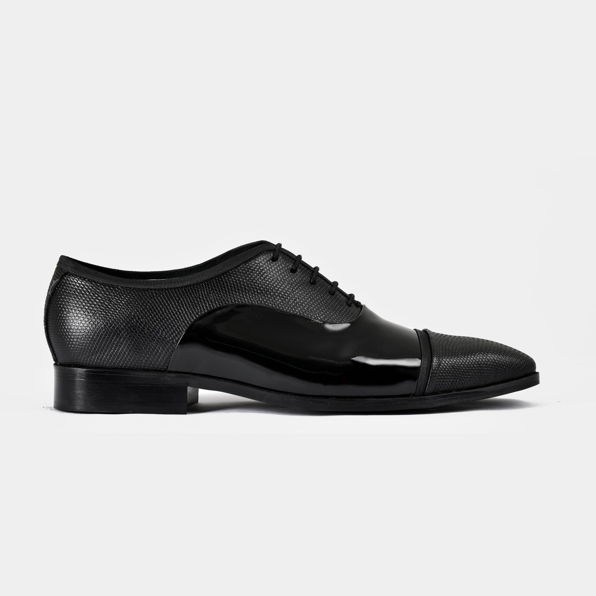 Pair of Ambros Patent black leather lace-up shoes with textured finish and a patent leather toe cap.