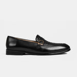 A side view of black leather Arlow Loafers, showcasing the woven buckle detail.