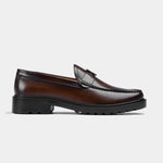 Pair of brown leather loafers with a metal buckle accent, showcasing the Solesculpt Lite sole for comfort.