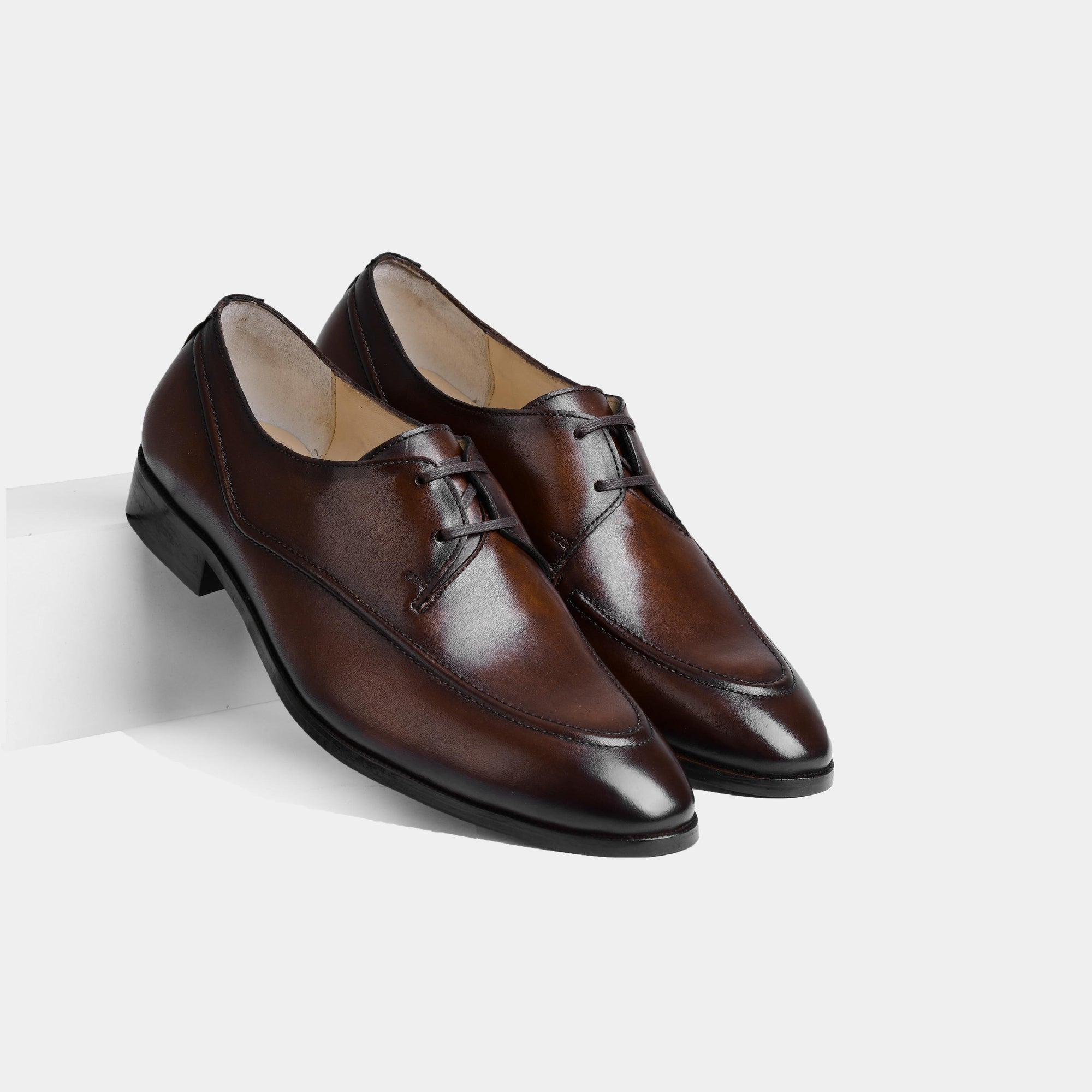 Pair of Marcos Brown Lace Up shoes, crafted from polished brown leather, on a white background.