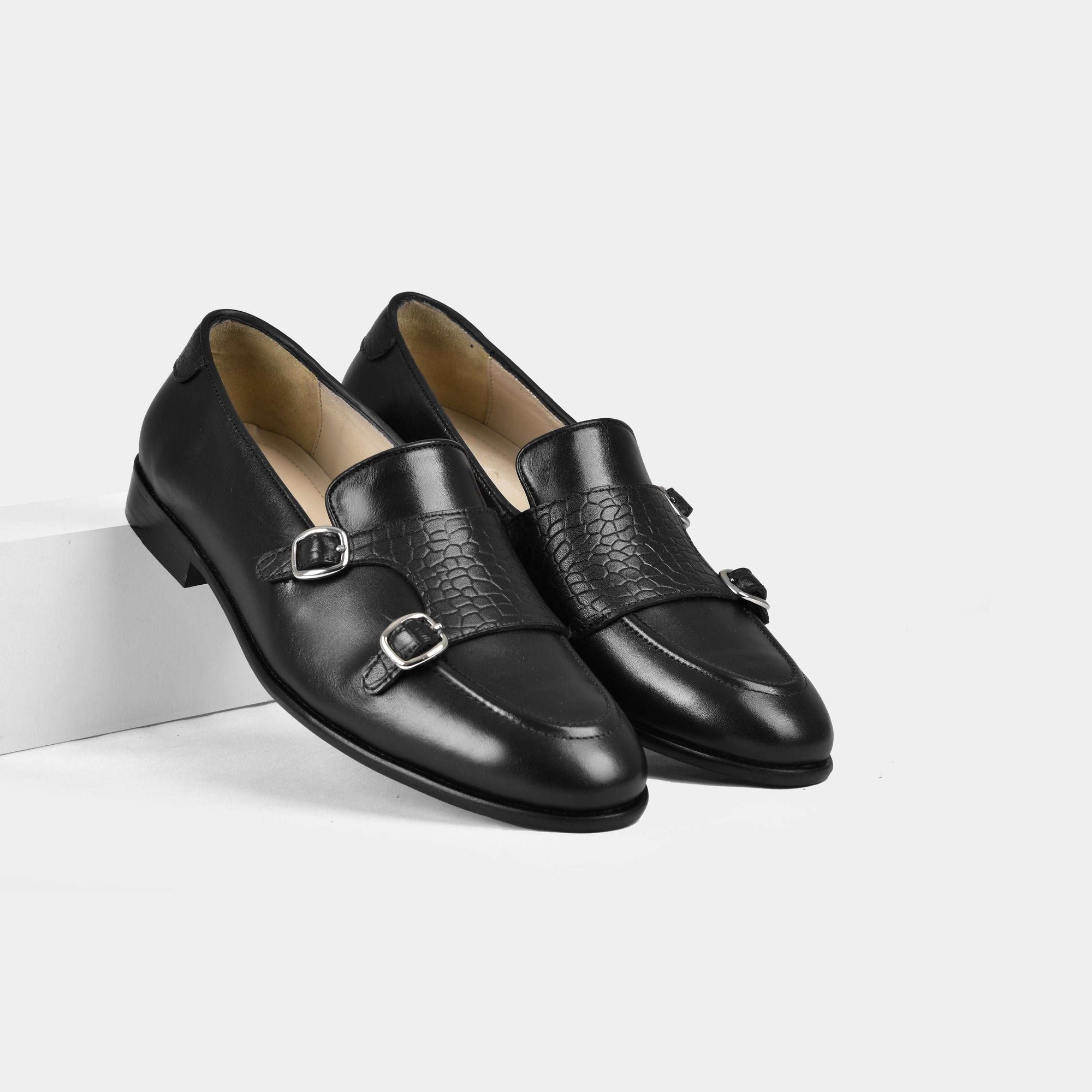 Pair of Armeo Black Leather Monk Straps with double buckles and a textured strap detail.