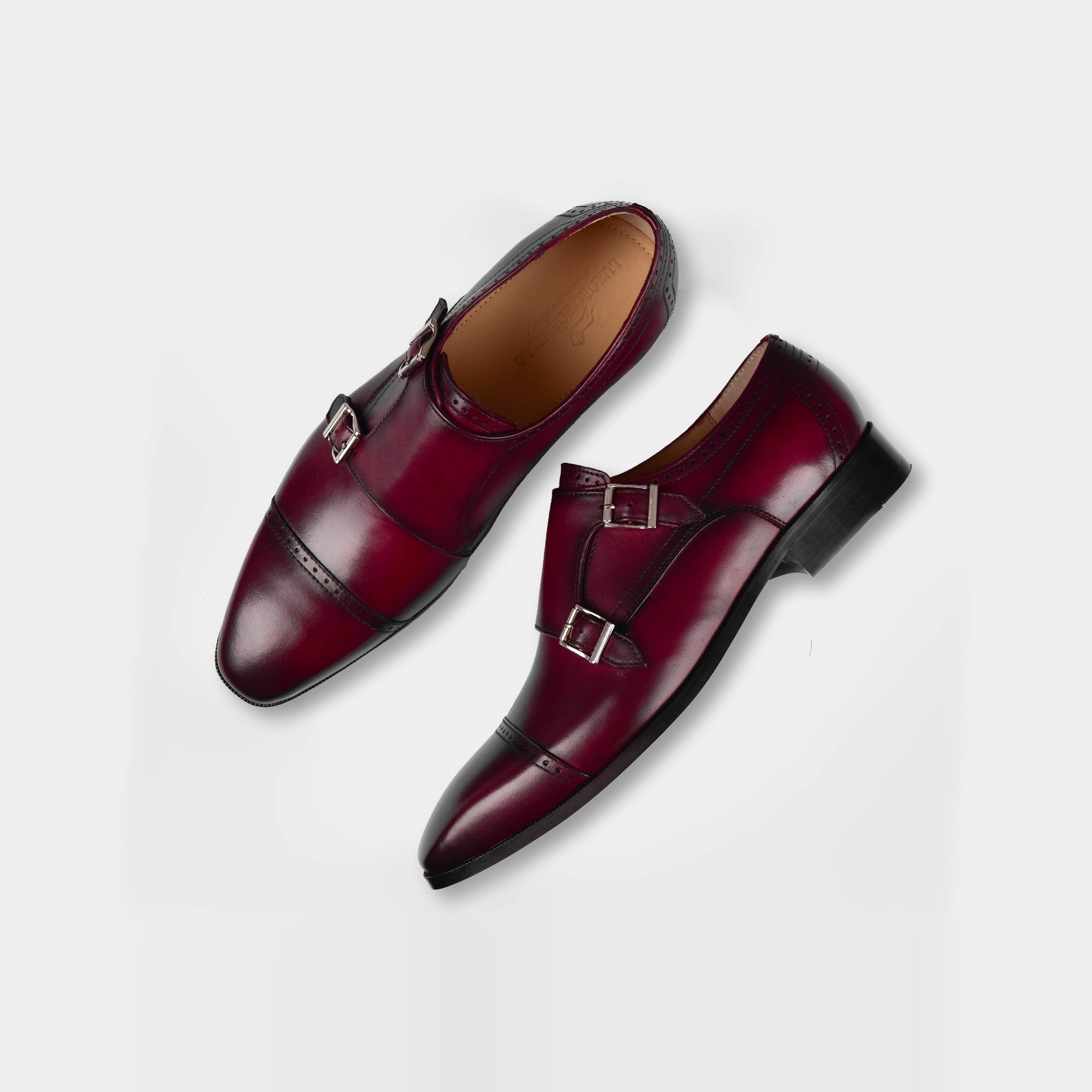 A pair of Tabor Ruby Leather Monk Straps in burgundy leather, featuring a classic double monk strap design and brogue detailing.