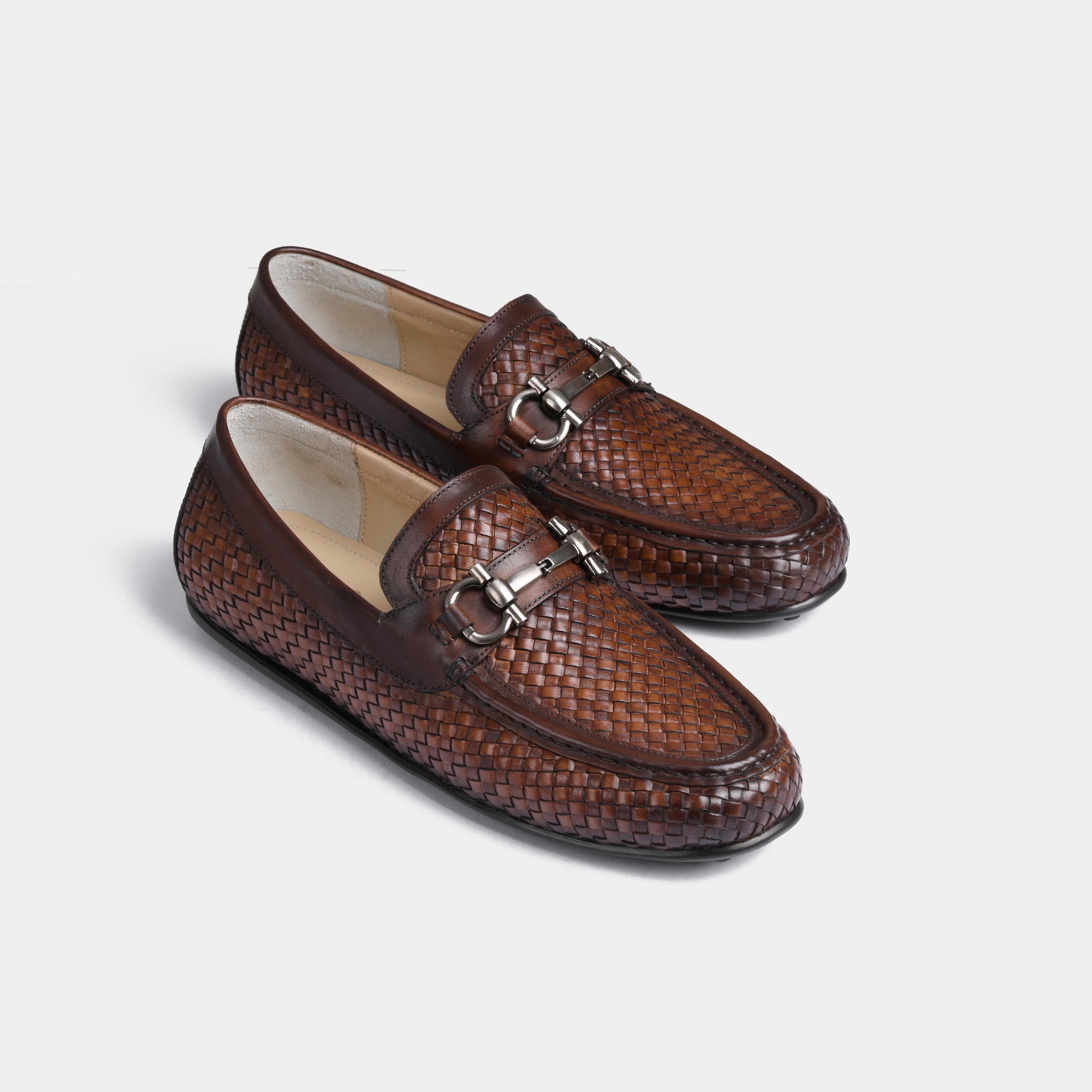 Pair of Lucio Weaved Brown Leather Driving Loafers with a woven design and silver buckle detail.