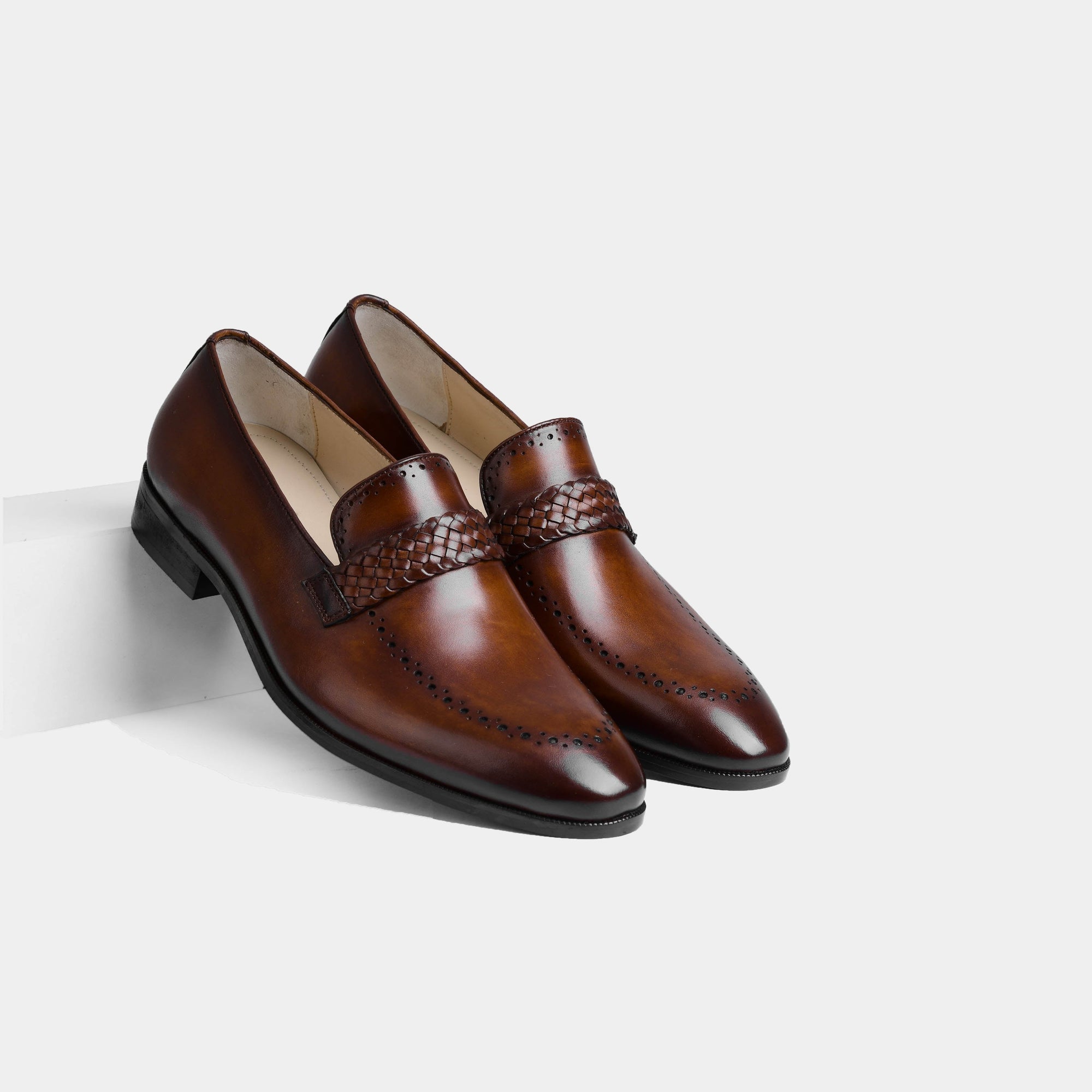 A pair of Alex Brown Leather Loafers with a woven strap detail, showcasing their rich brown leather and sophisticated design.