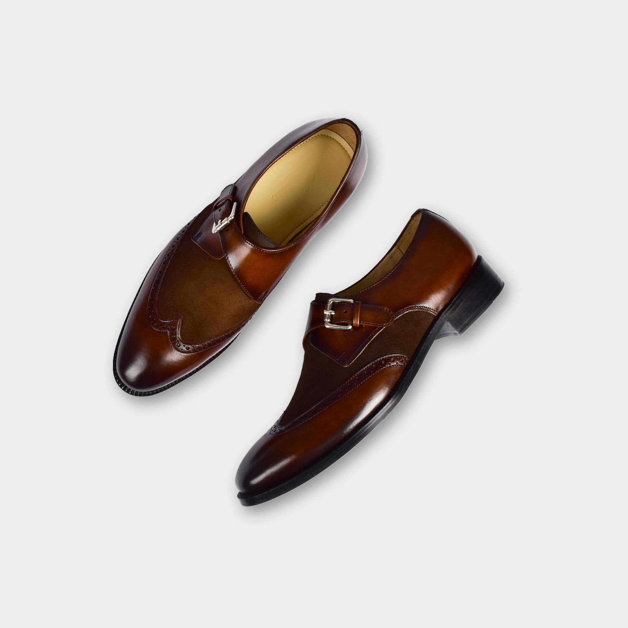 Pair of Chris Miller Leather Monk Straps in brown leather with a wingtip design and suede accent panel.