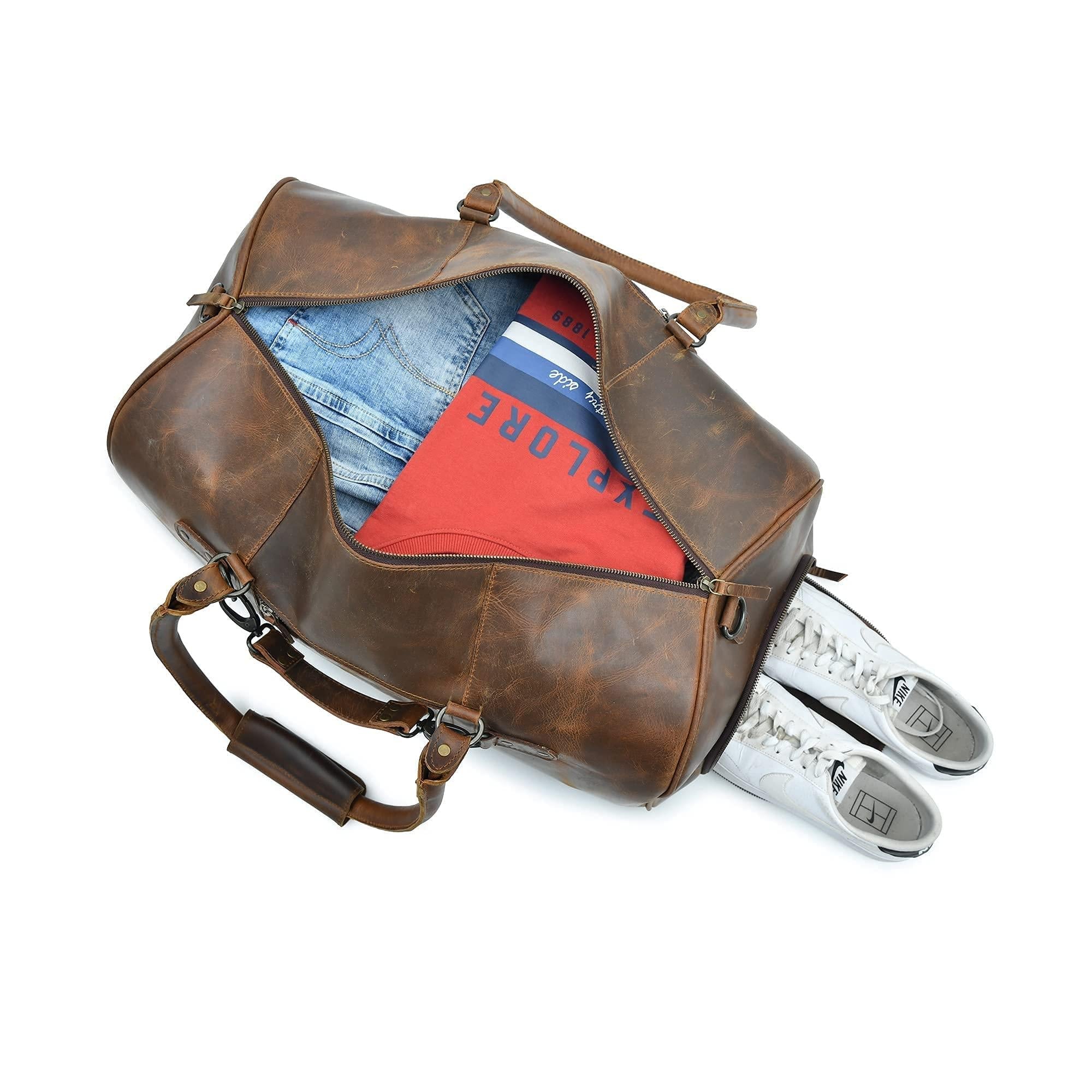 Open brown leather duffle bag packed with clothes and shoes, showcasing its spacious interior and separate shoe compartment.