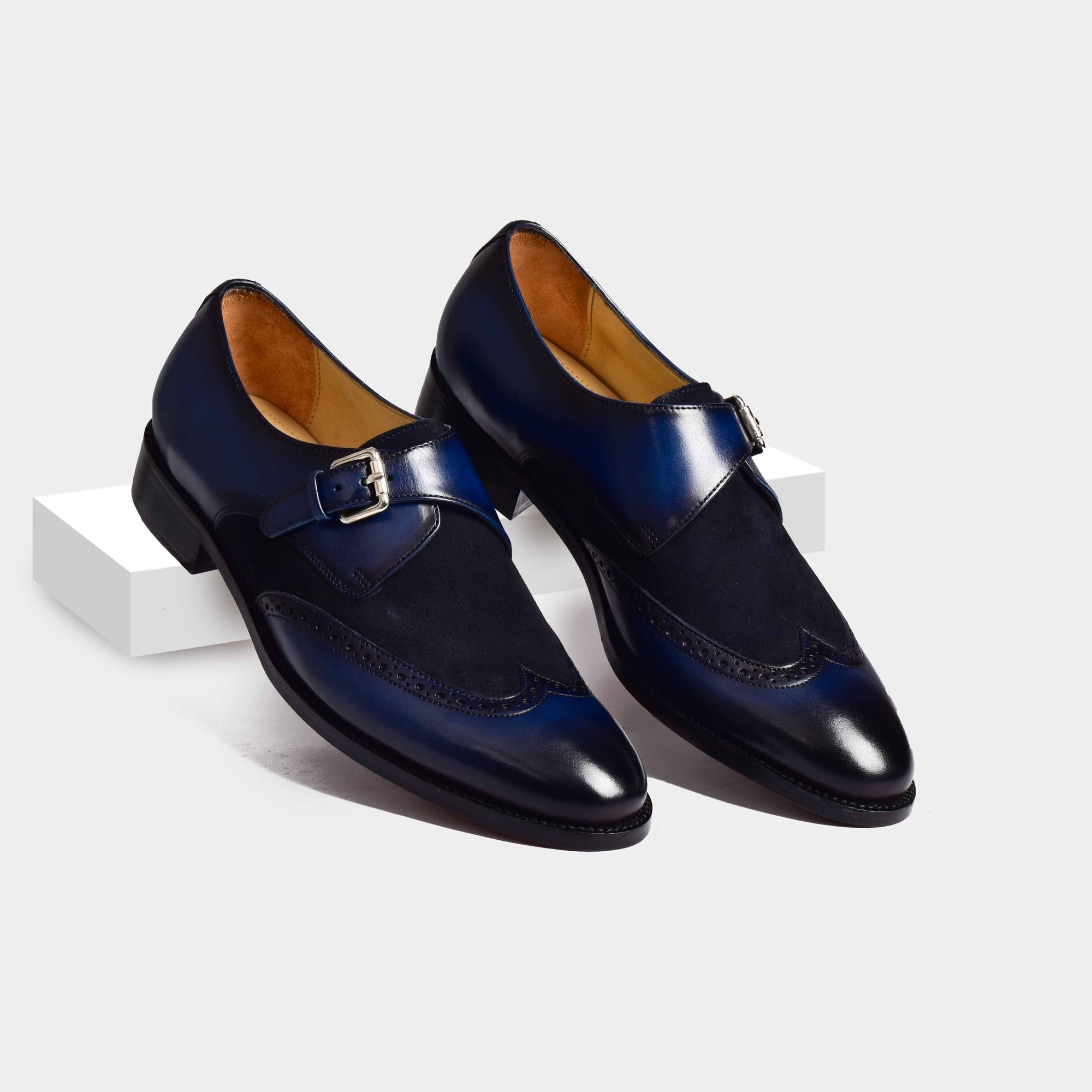 Pair of Bruce Blue Single Leather Monk Strap shoes with broguing and a single buckle closure.