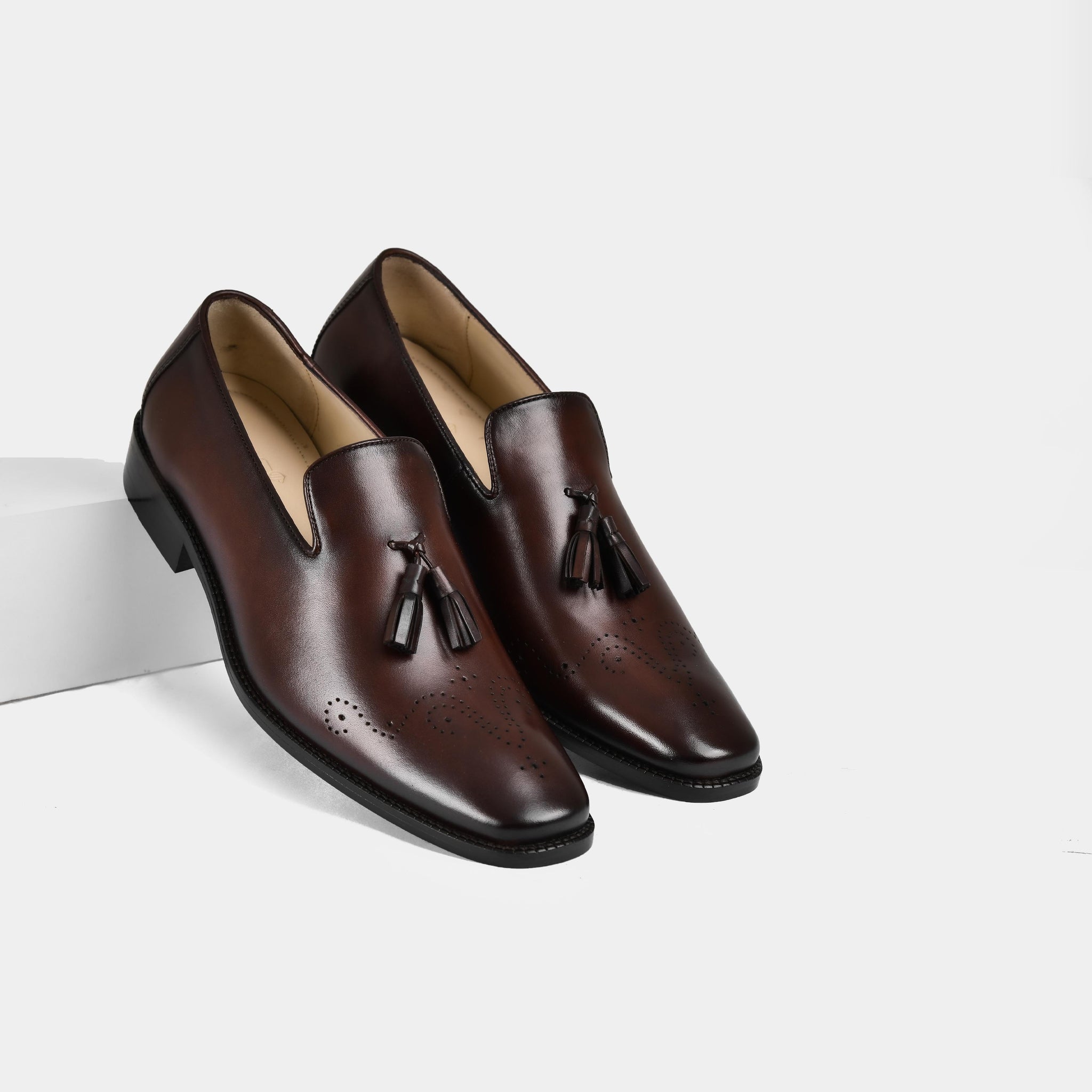 Pair of Vincenz Brown Leather Loafers with tassel accents and brogue detailing.