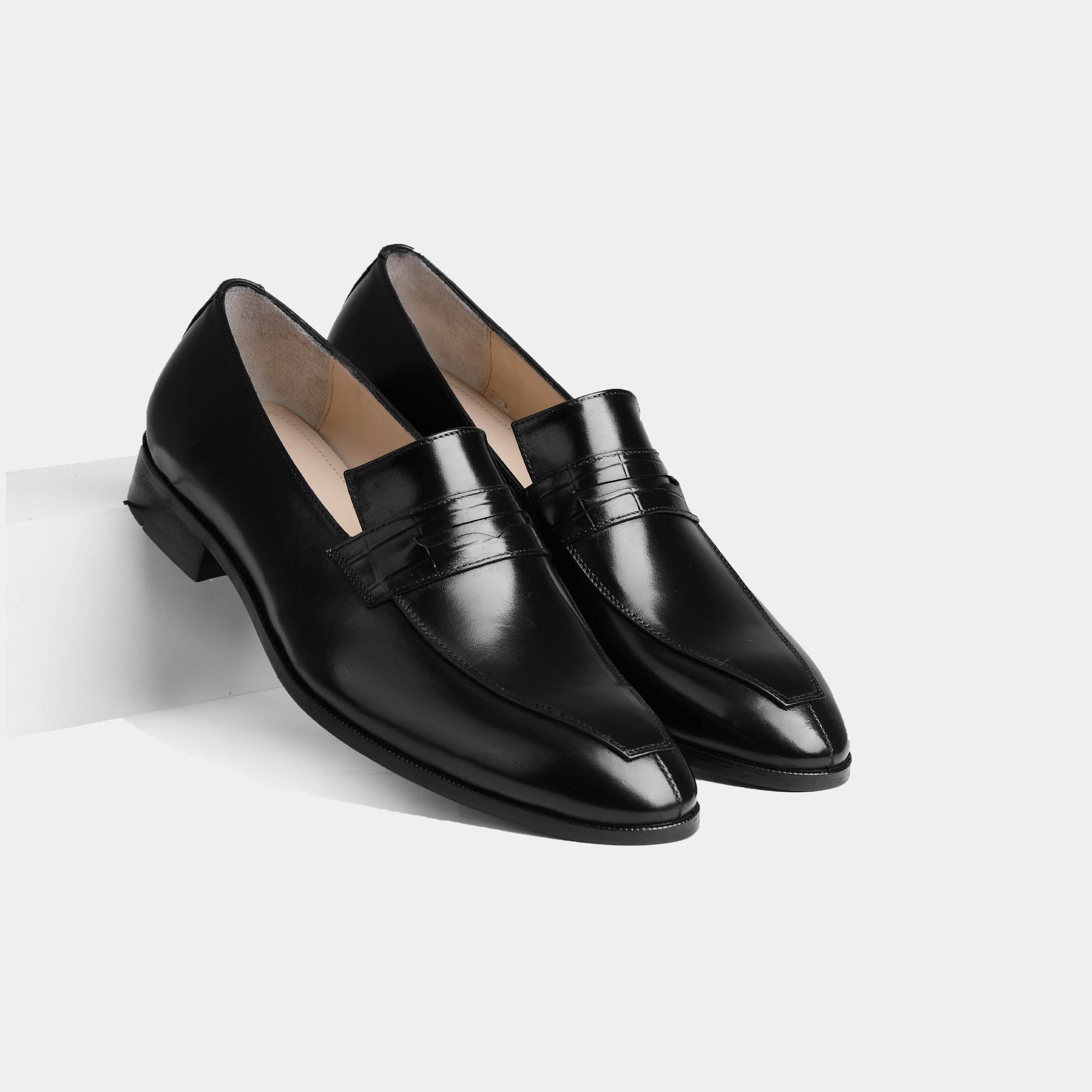 Pair of Alarico Black Leather Loafers with a sleek, polished finish and a saddle strap detail.