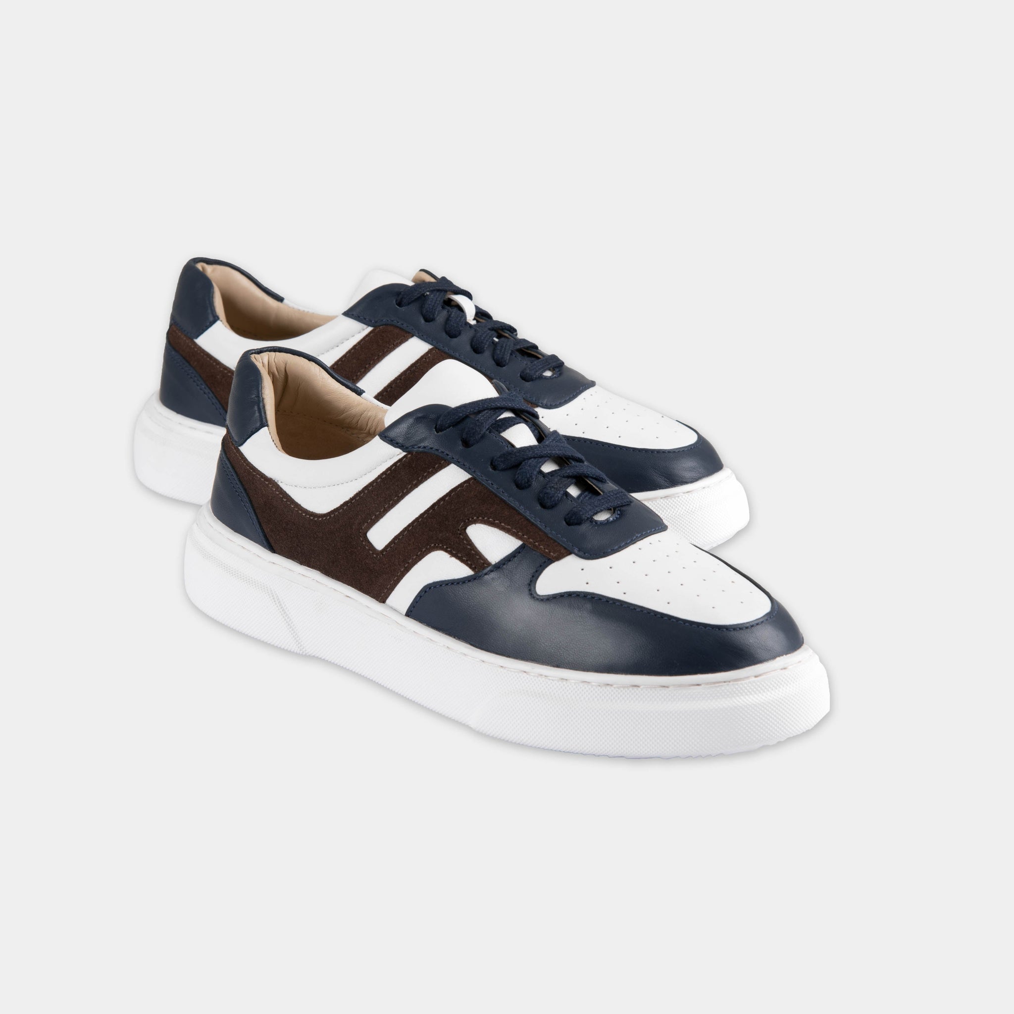 Pair of Classic Luxoro LF Leather Sneakers in navy blue, brown, and white leather with white soles.